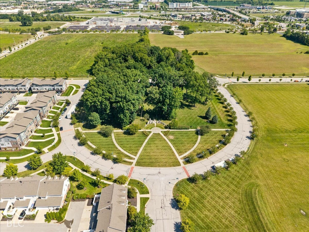 Residential community featuring townhomes, green spaces, and mature trees