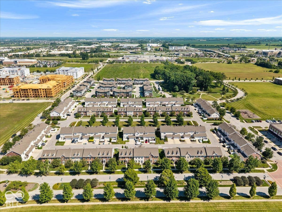 Community featuring multiple residential structures, manicured green spaces, and established tree-lined streets