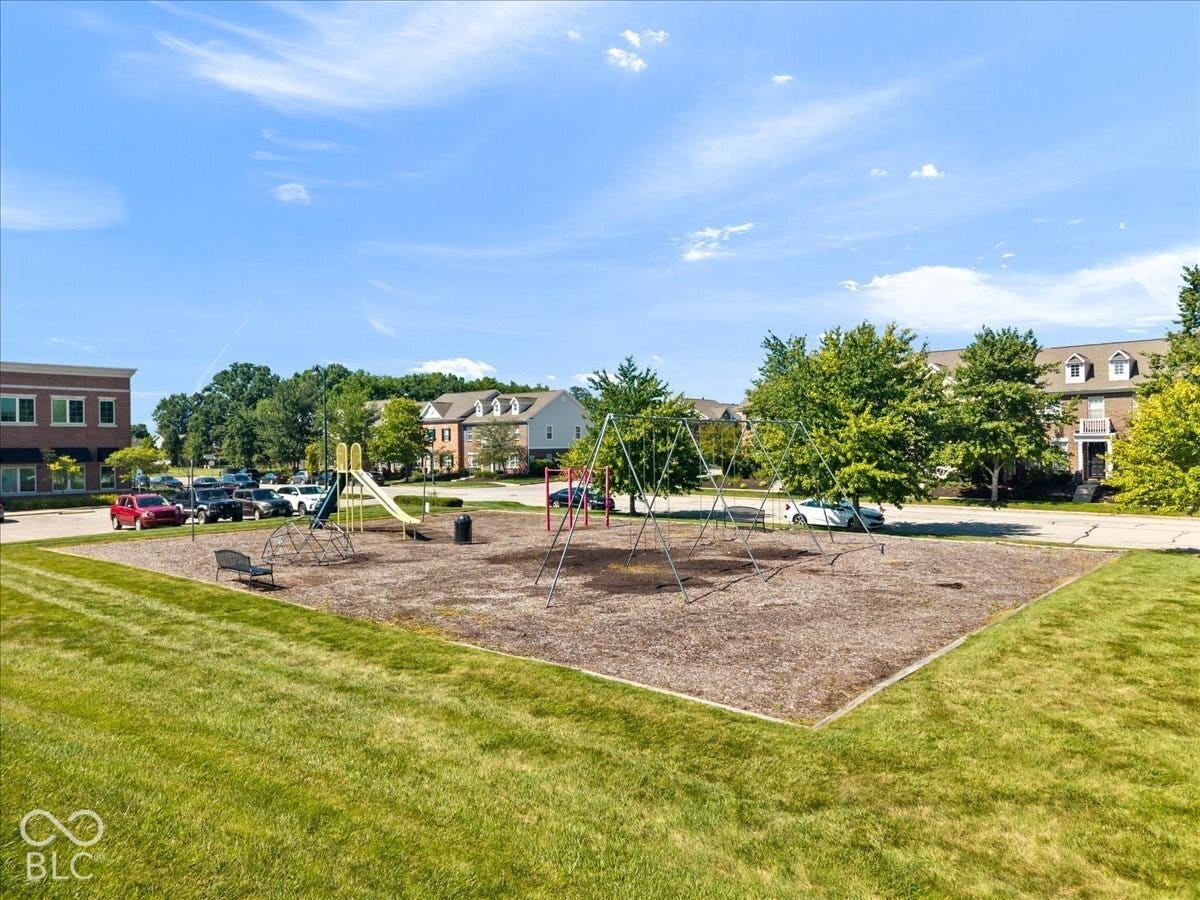 Recreational area featuring a swing set, slide, and a climbing structure