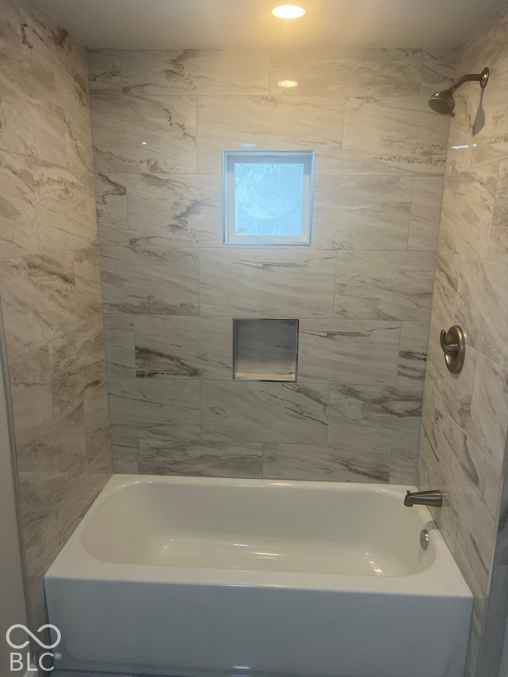 Tile surround bath with integrated niche and window