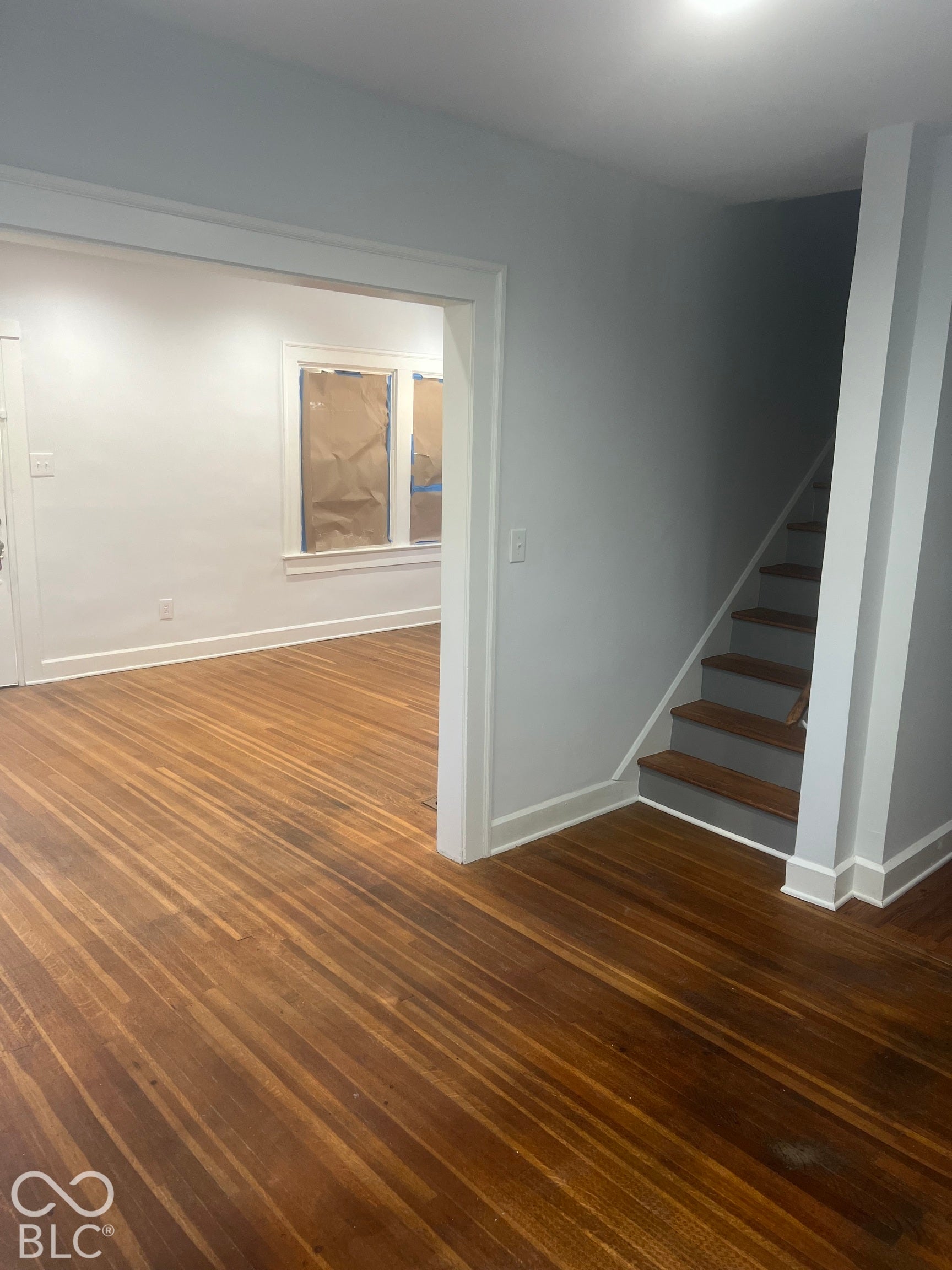 Warm wood-finish flooring extending into an adjacent room