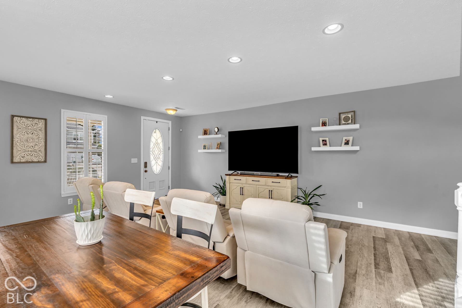 Recessed ceiling lighting, wood-finish flooring, white trim, white front door with decorative glass, and gray wall paint