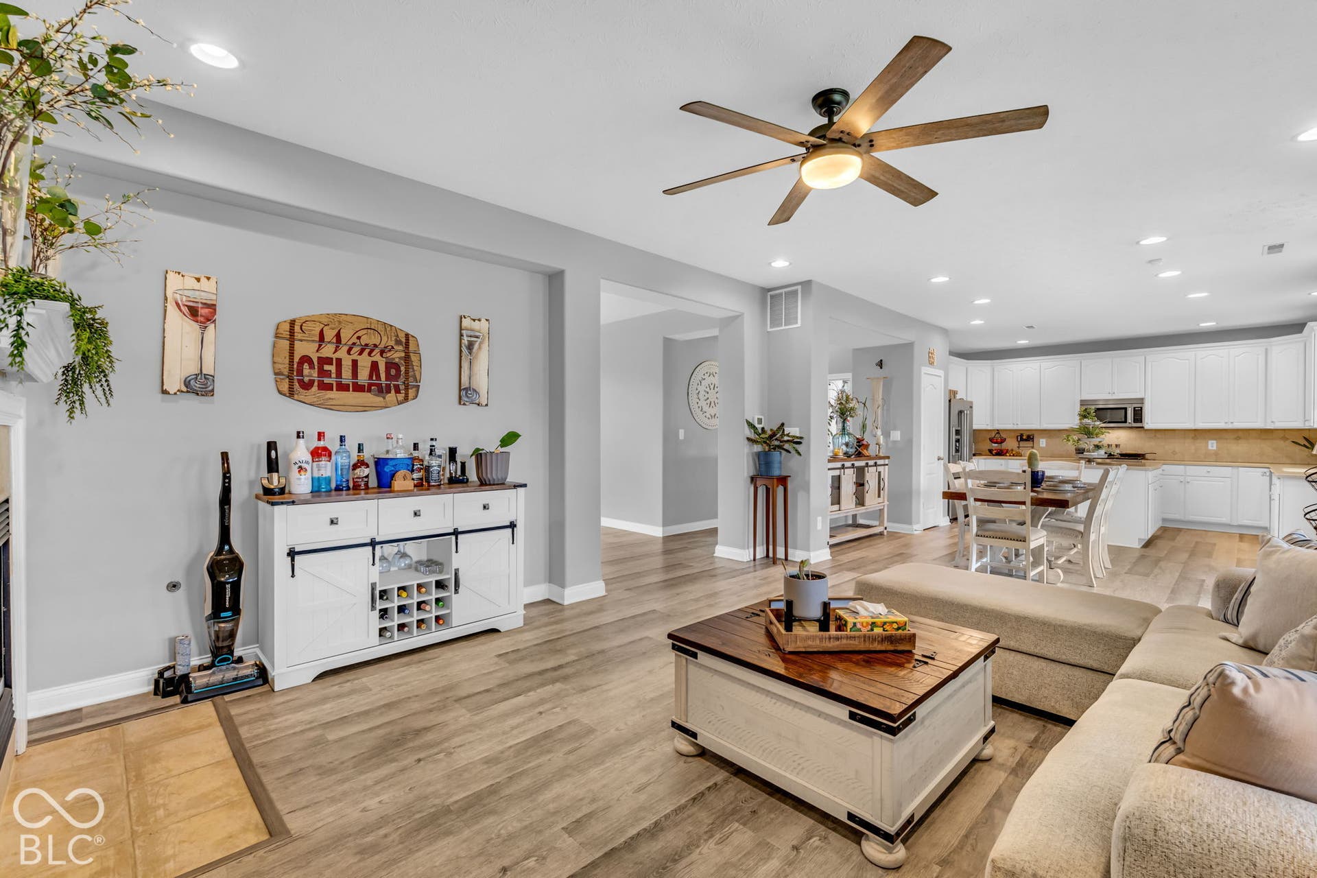 Open-concept living space featuring wood-finish flooring, recessed lighting, and a ceiling fan
