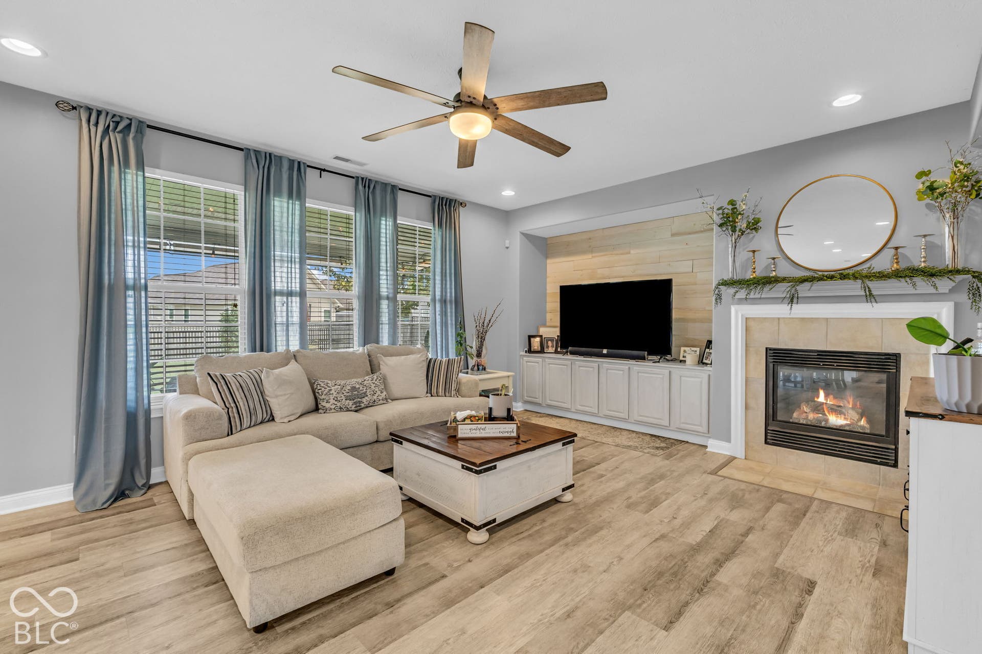 Wood-finish flooring, recessed lighting, and a ceiling fan