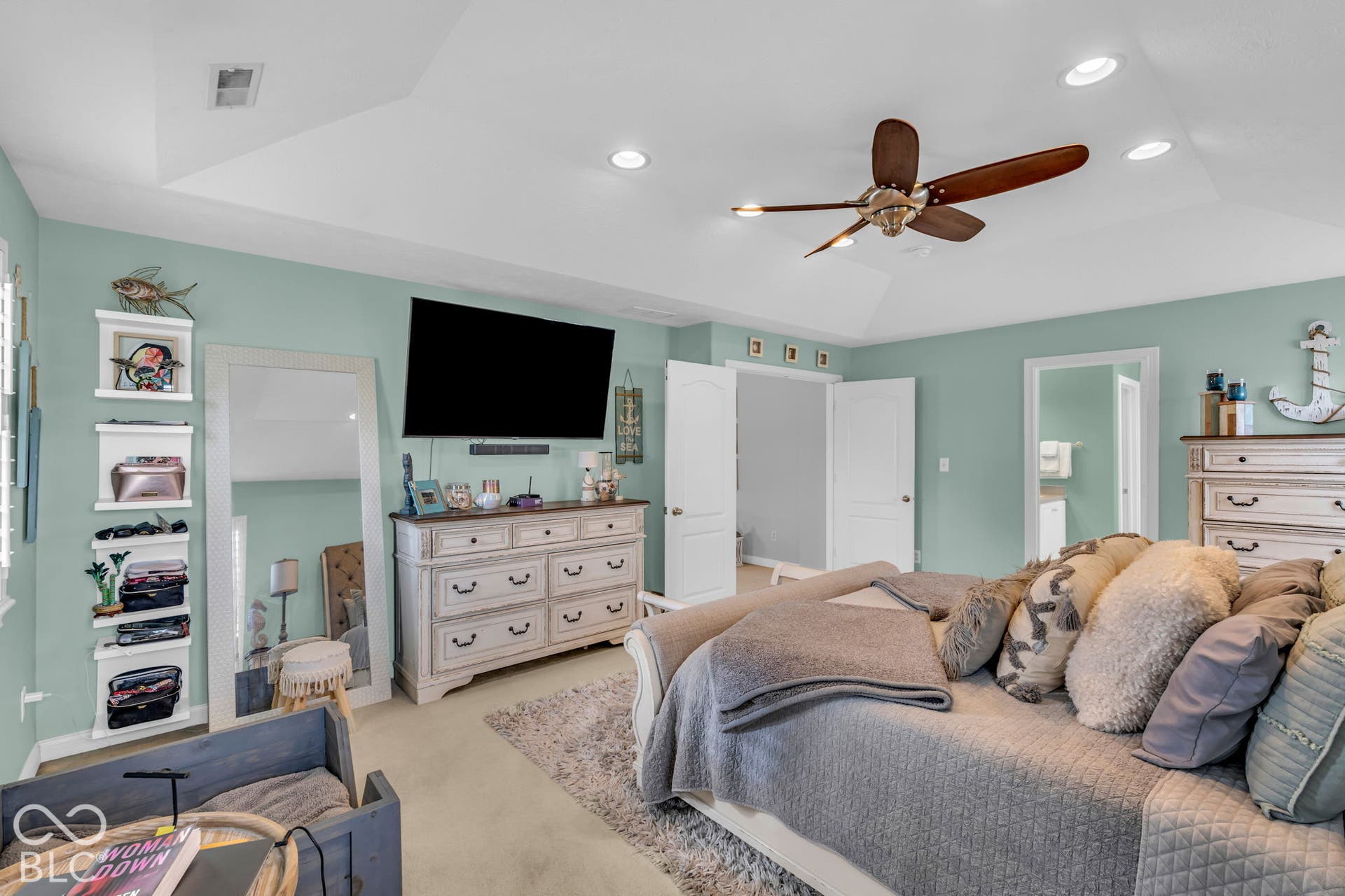 Tray ceiling with recessed lighting, ceiling fan, and light-toned wall color