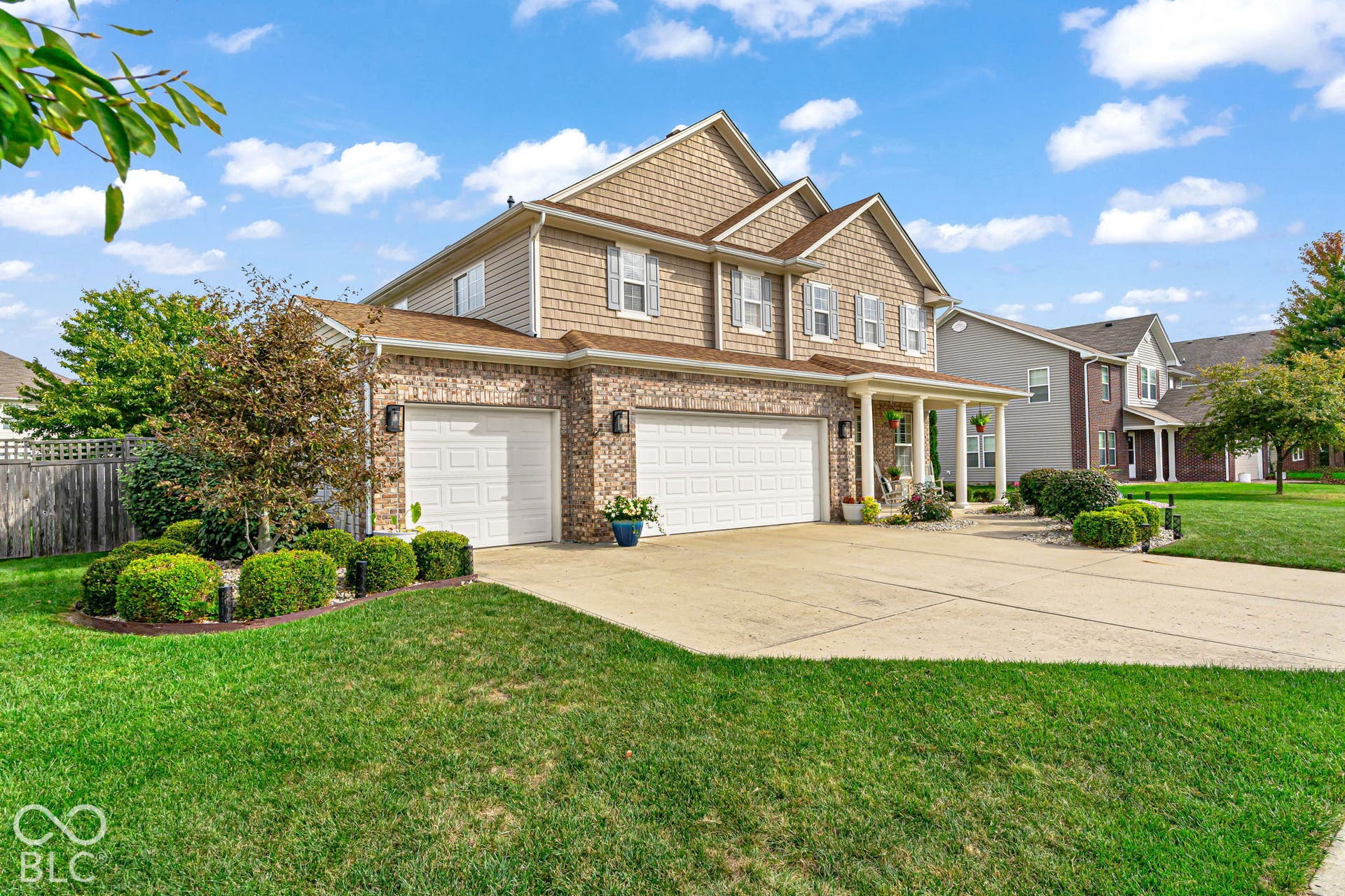 Brick and shake exterior with a three-car garage