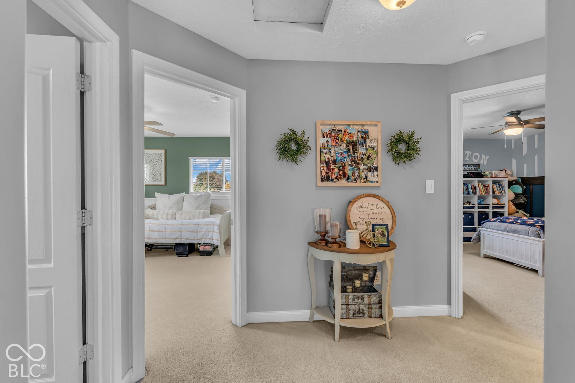 Carpeted hallway with light gray walls
