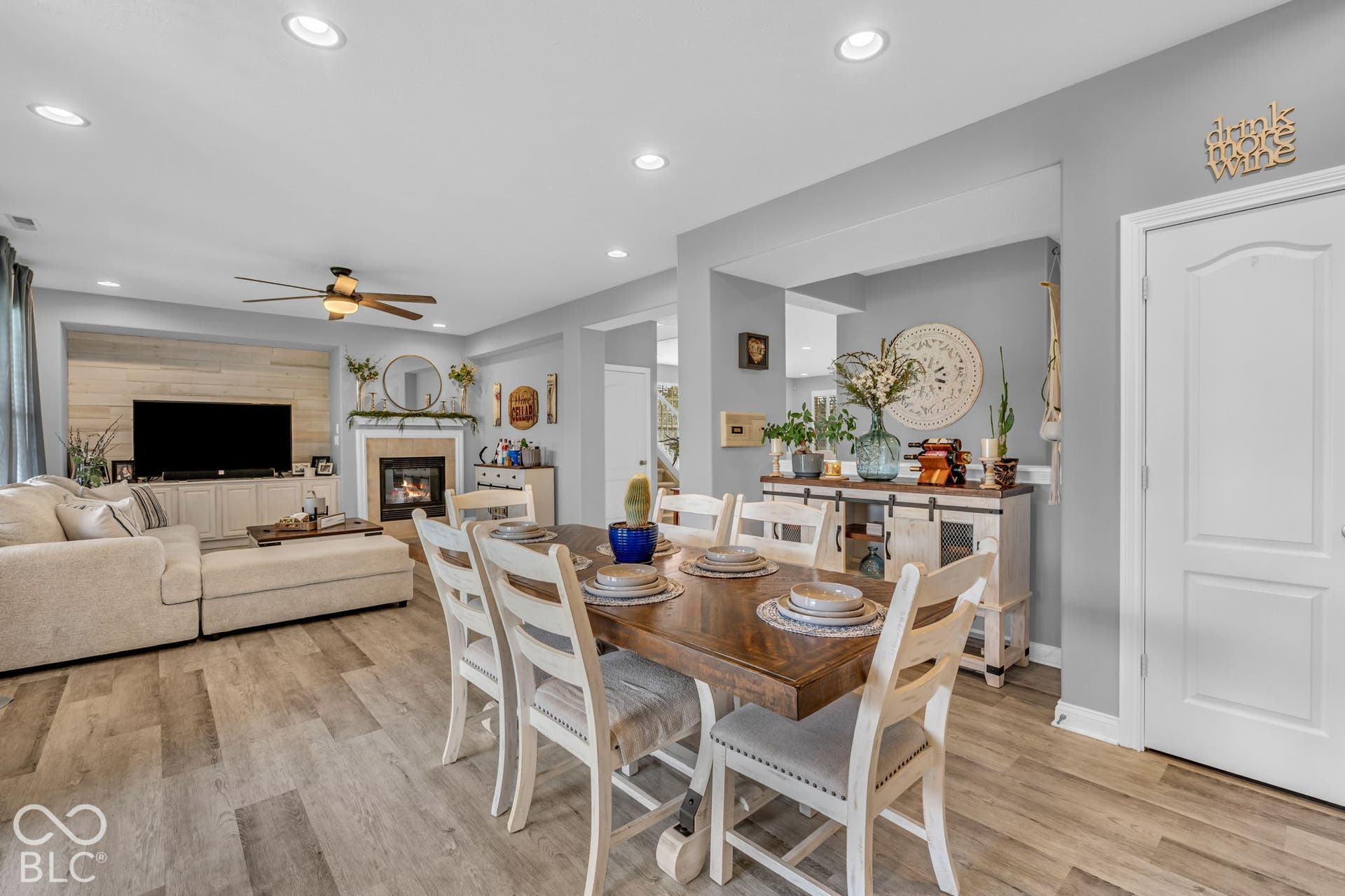 Open-concept living space featuring wood-finish flooring, recessed lighting, and a ceiling fan