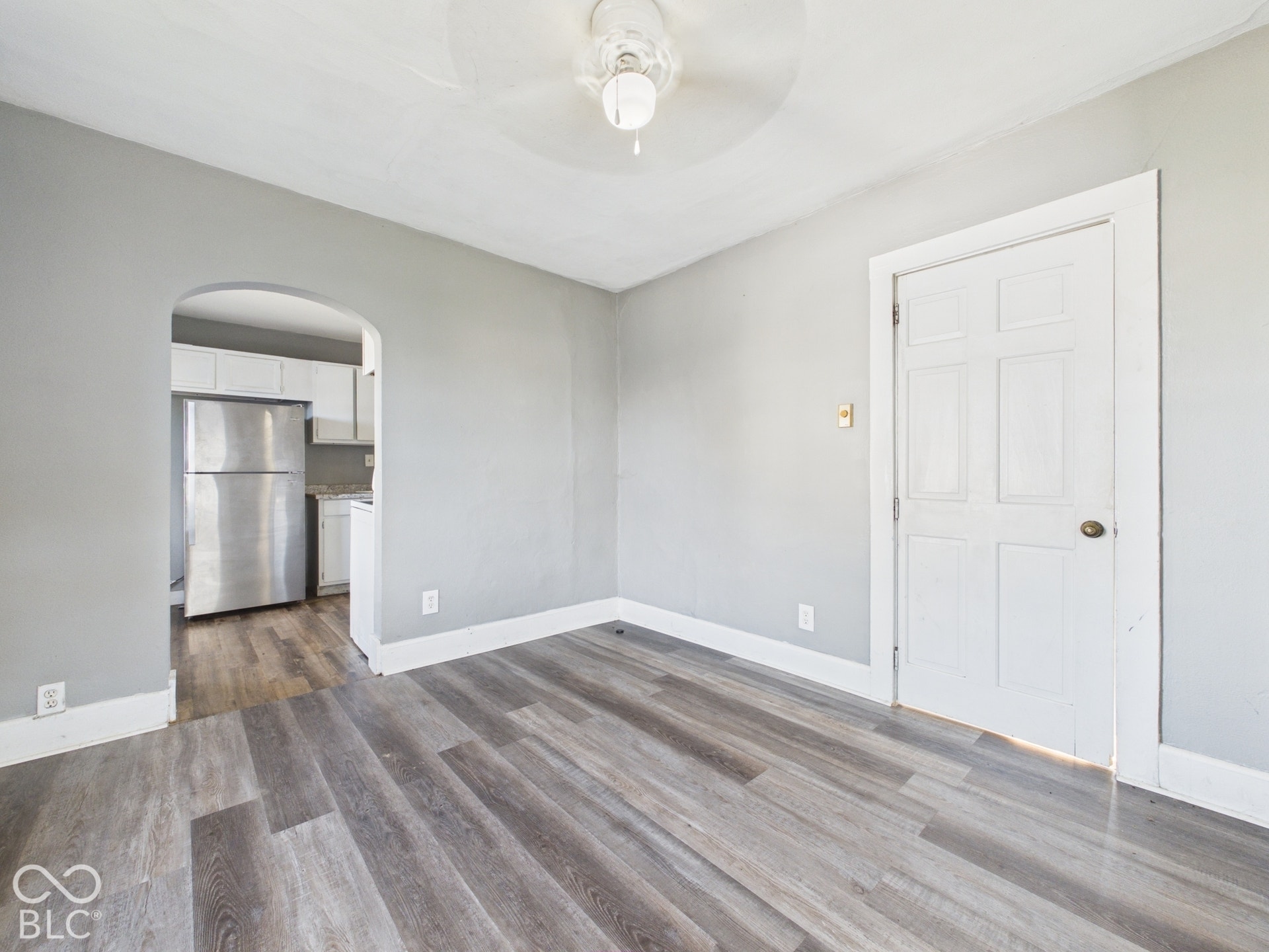 Wood-finish flooring throughout, paired with light gray wall tones