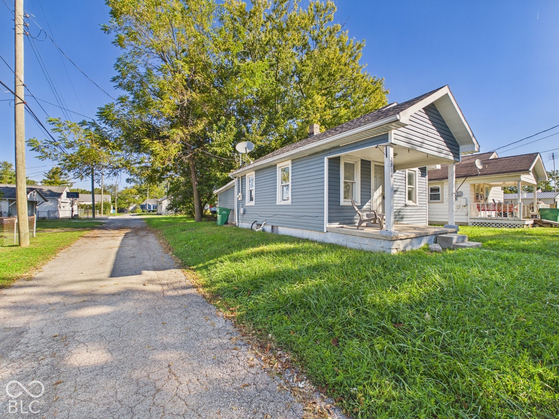 Light blue siding exterior with a covered front porch and concrete steps