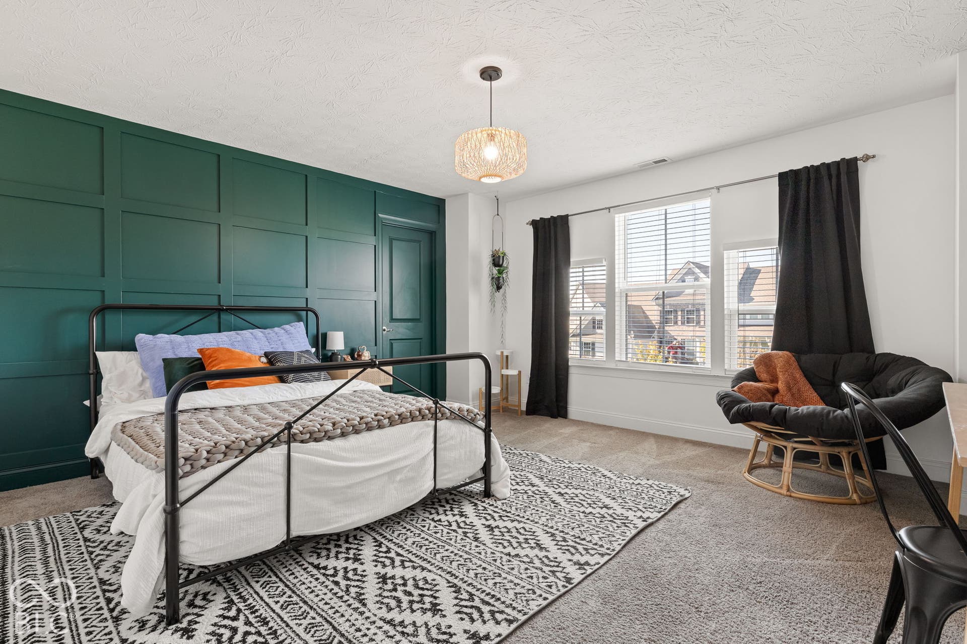Accent wall with panel molding, single door, three windows, and overhead lighting fixture
