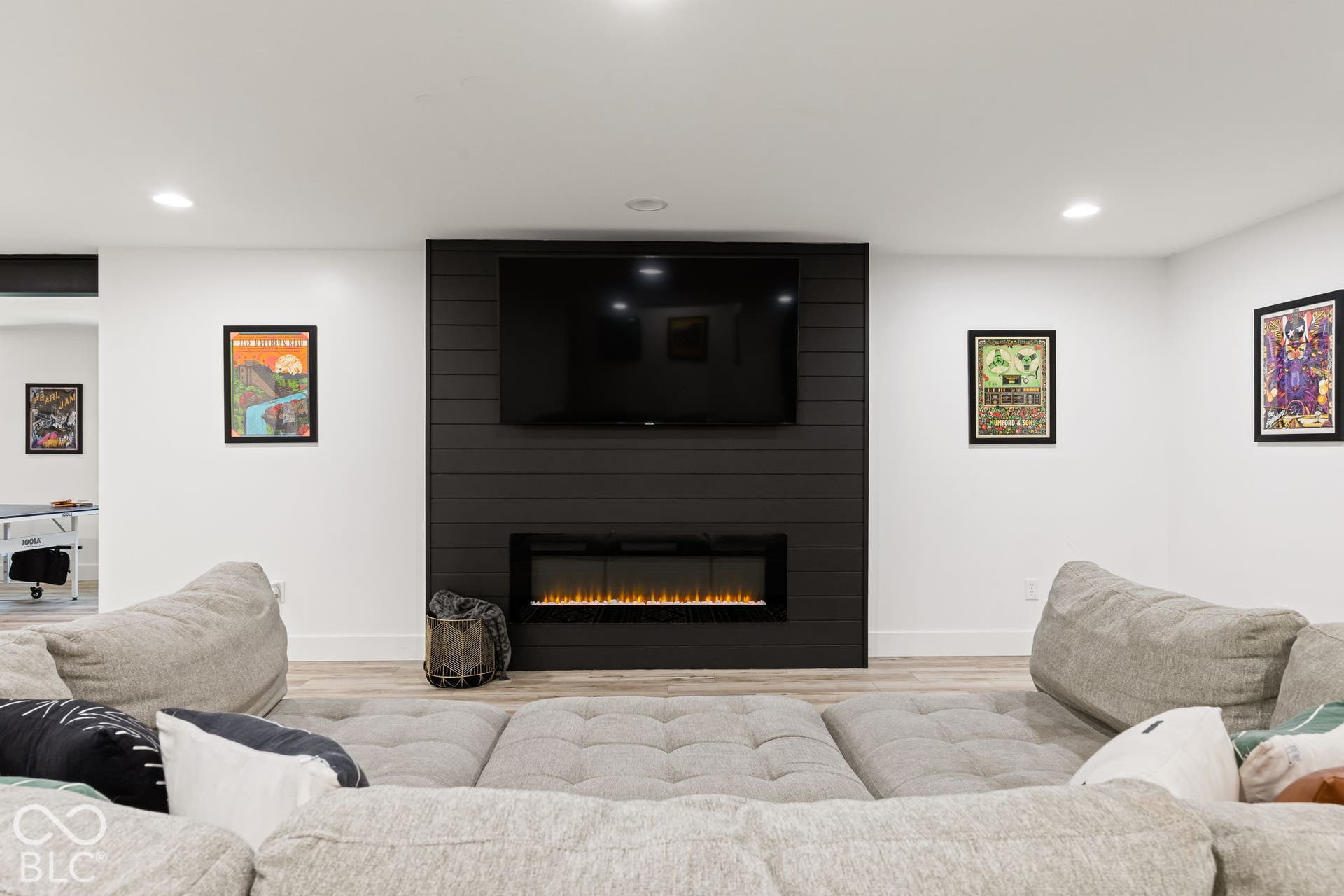 Accent wall with dark shiplap paneling and an integrated electric fireplace