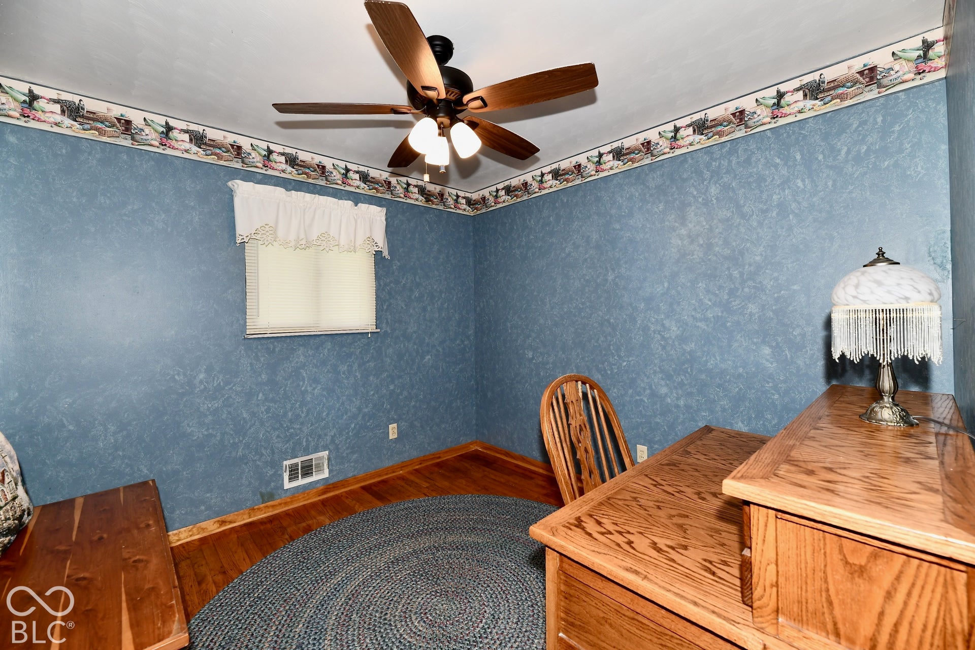 Bedroom 2  with refinished hardwood flooring, a ceiling fan with integrated lighting, and fire proof safe (closet, bolted to the floor)