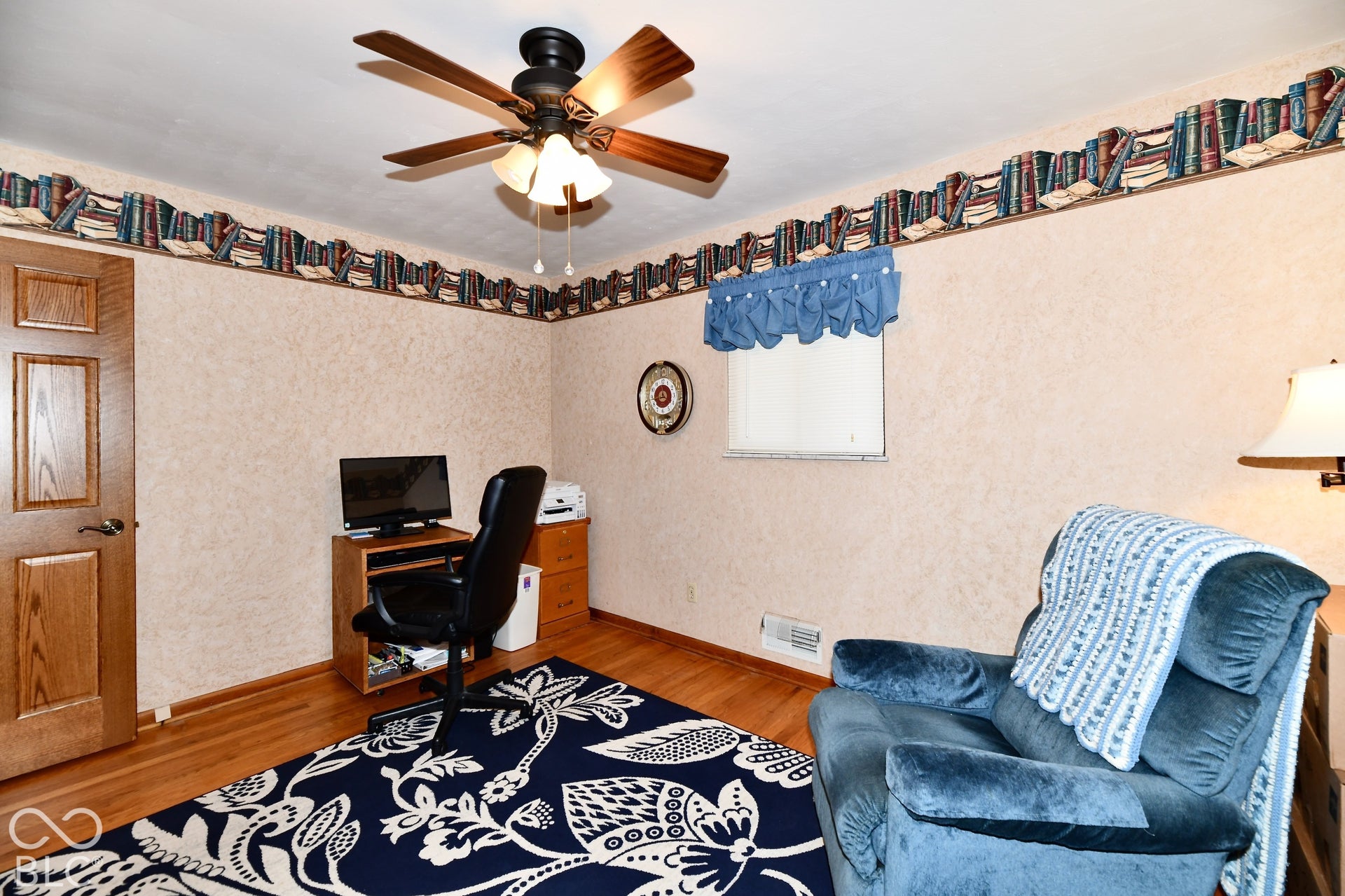 Bedroom 3 features refinished hardwood flooring, ceiling fan with integrated lighting, and ample storage/ closest space
