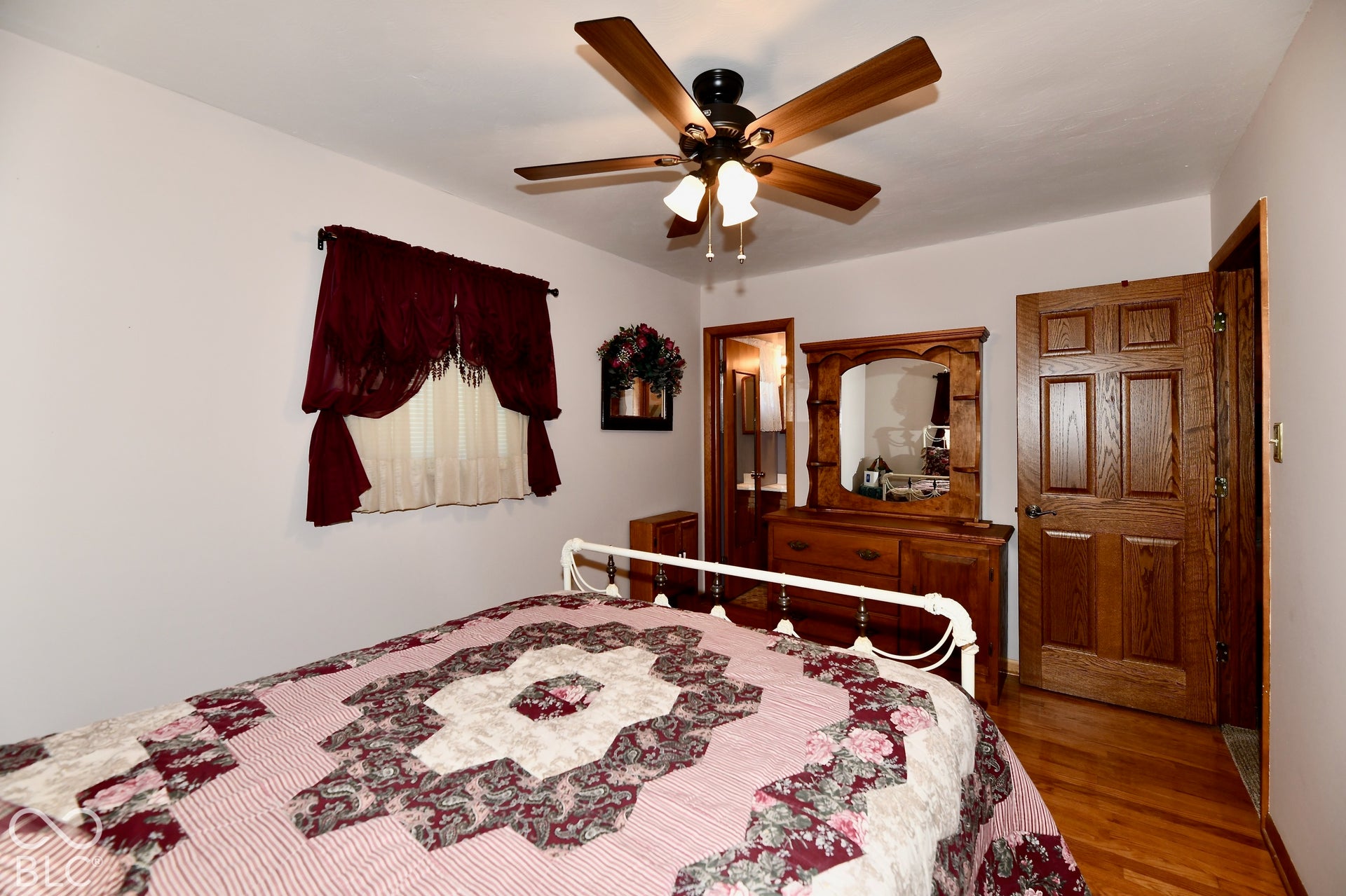 Bedroom 4 features refinished hardwood flooring, a 1/2 bath ensuite and deep closet storage space.