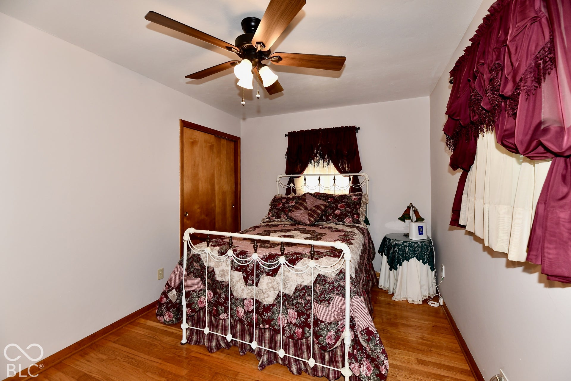 Bedroom 4 features refinished hardwood flooring, a 1/2 bath ensuite and deep closet storage space.