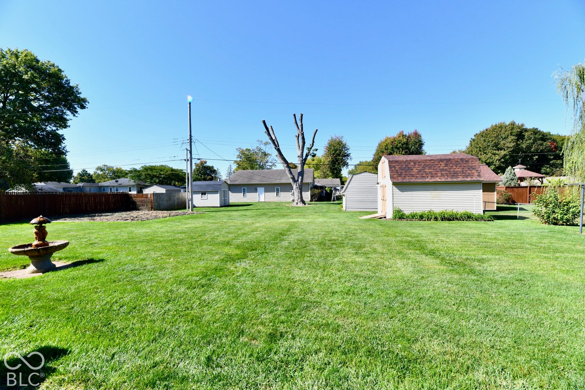 Spacious rear yard with storage barn