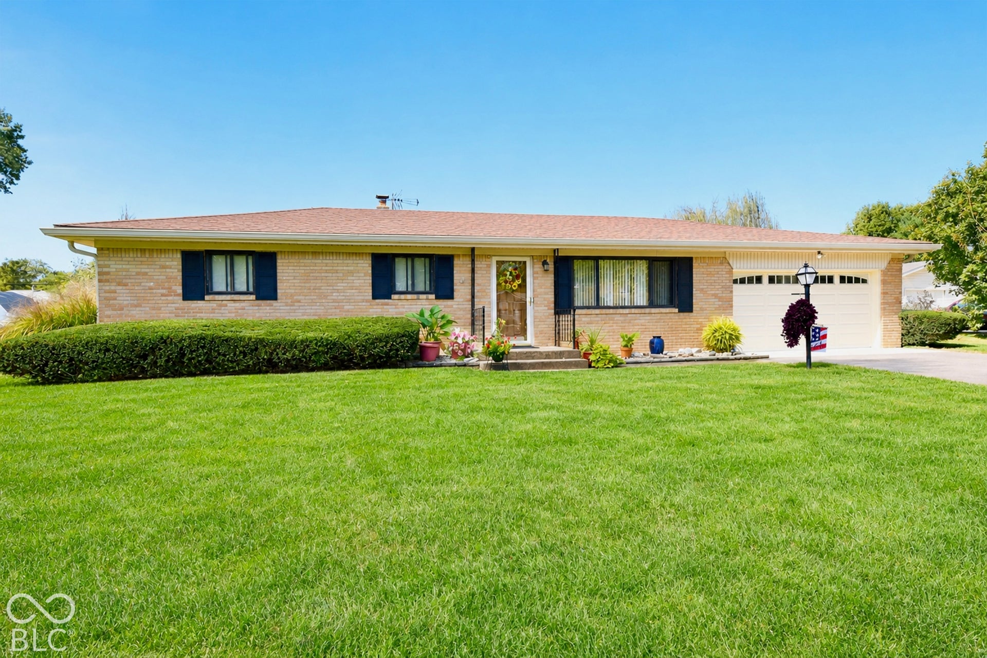 Low maintenance exterior, attached garage with neutral door, and curb appeal