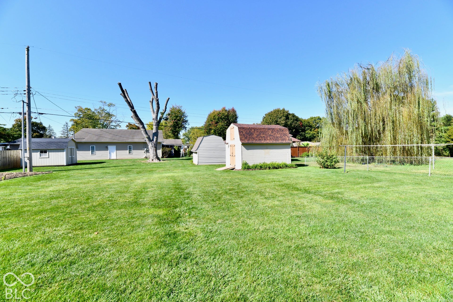 Spacious rear yard with storage barn