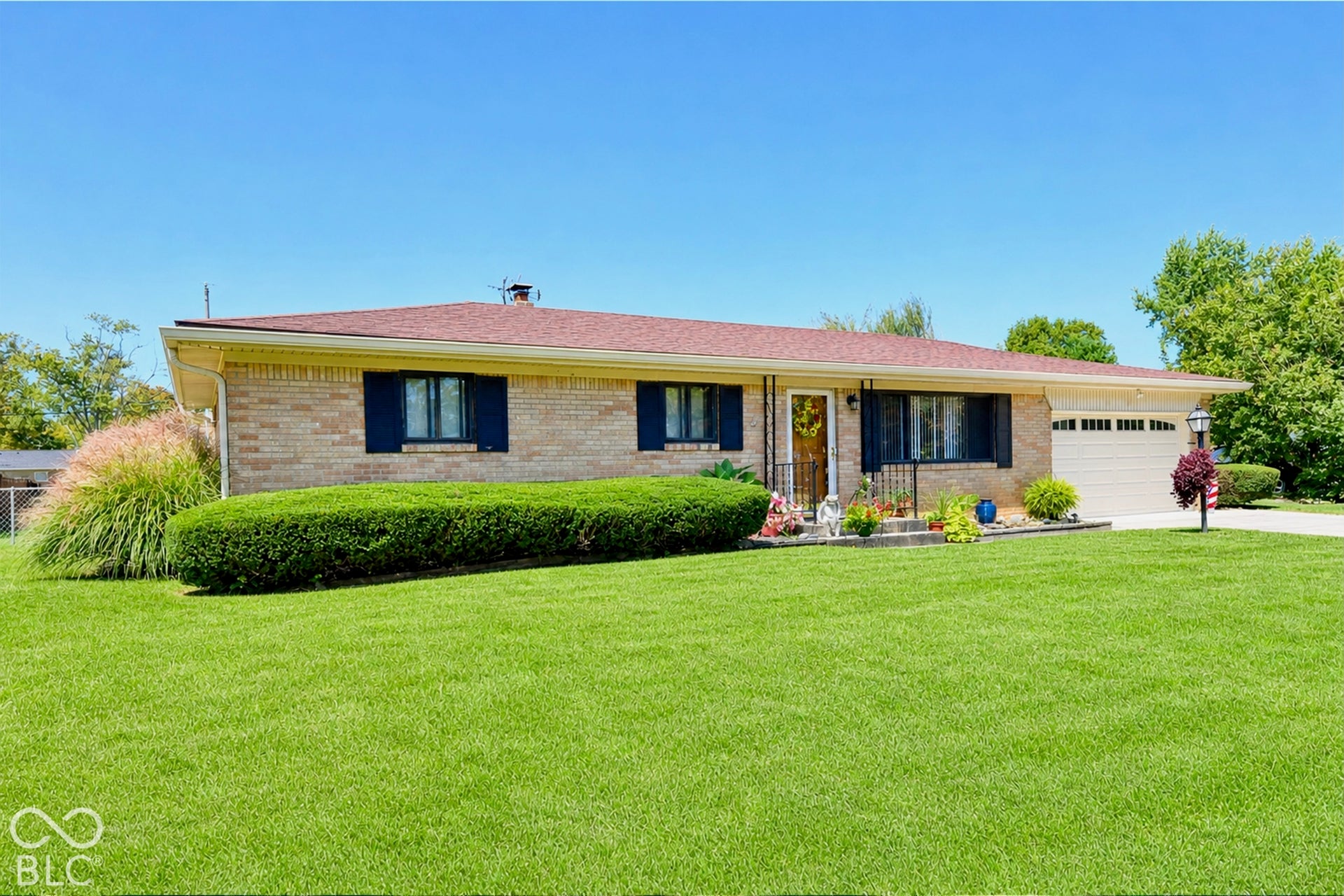 Low maintenance exterior, attached garage with neutral door, and curb appeal