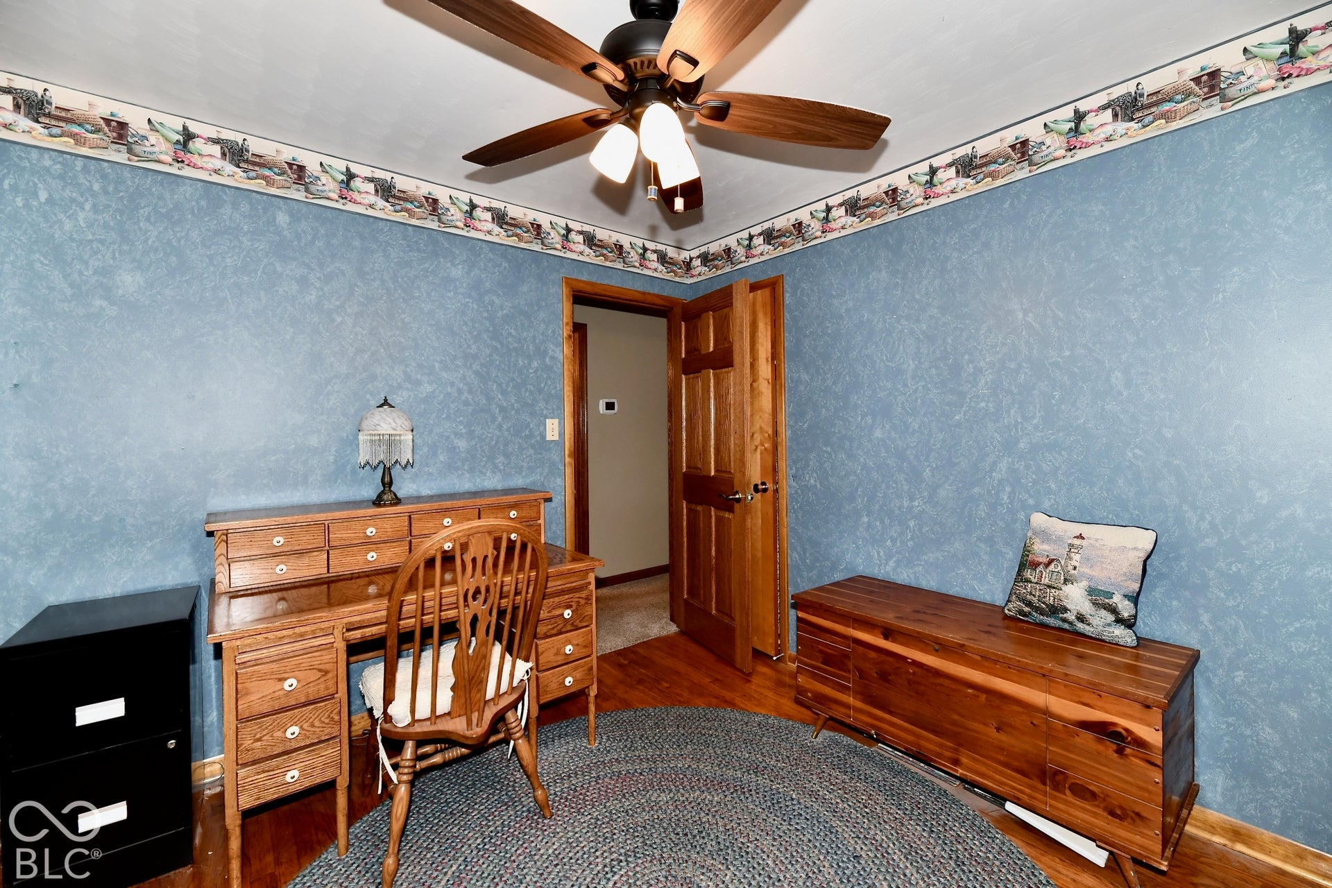 Bedroom 2 with refinished hardwood floors and ceiling fan