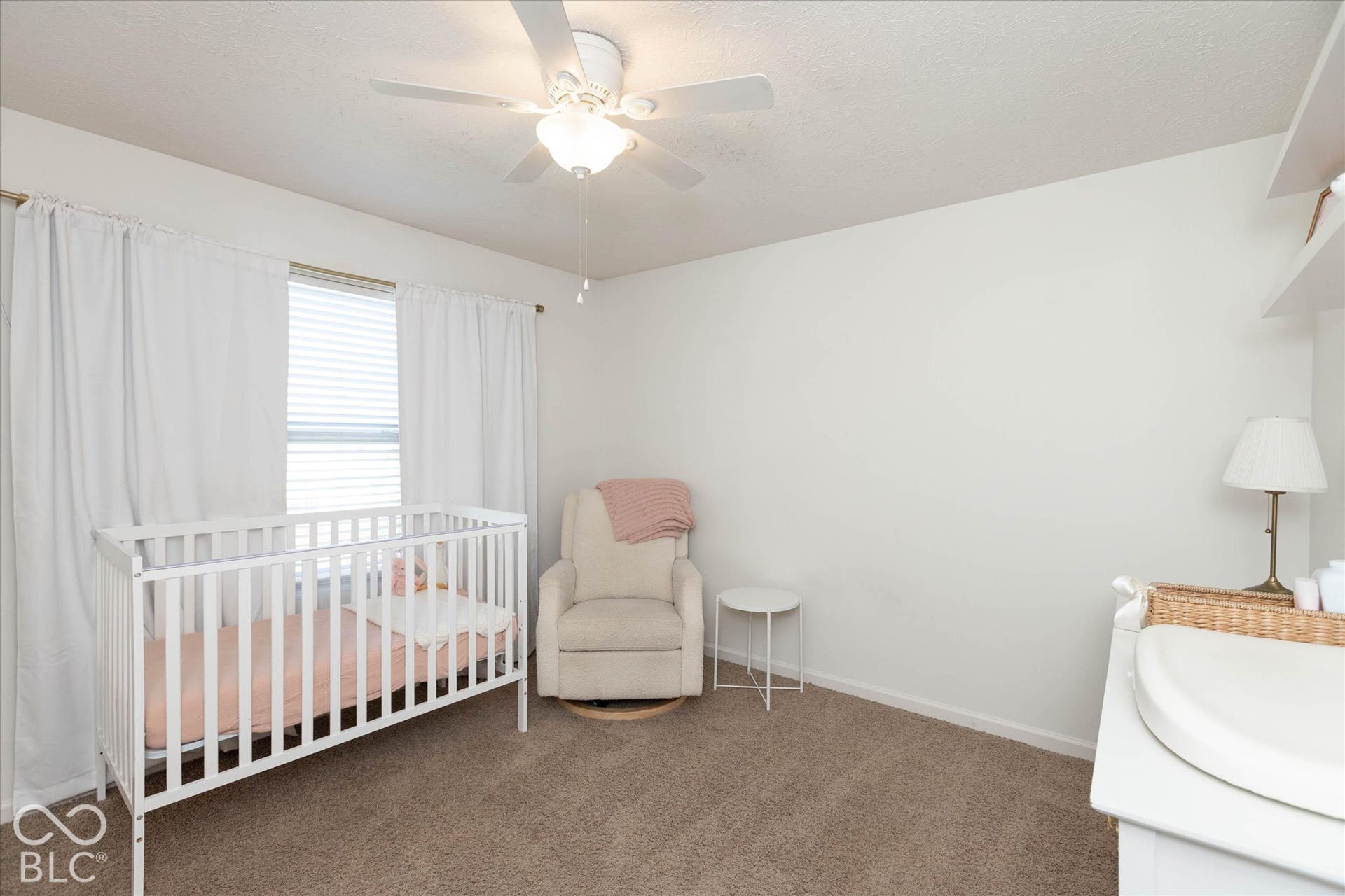 Bedroom #2:  Wall-to-wall carpeting with light-toned walls and a window with blinds