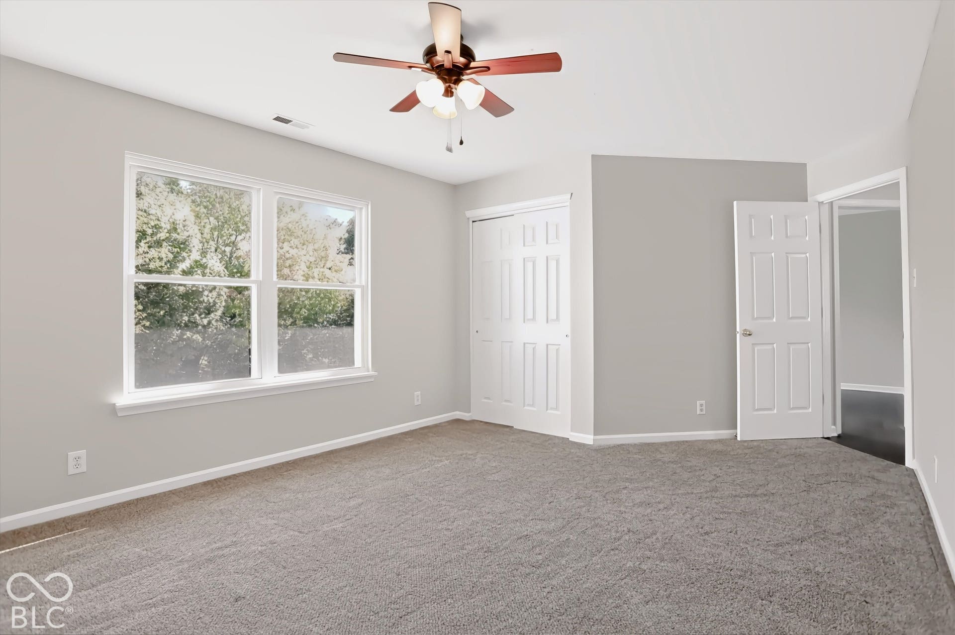Neutral-toned walls complement plush carpeting