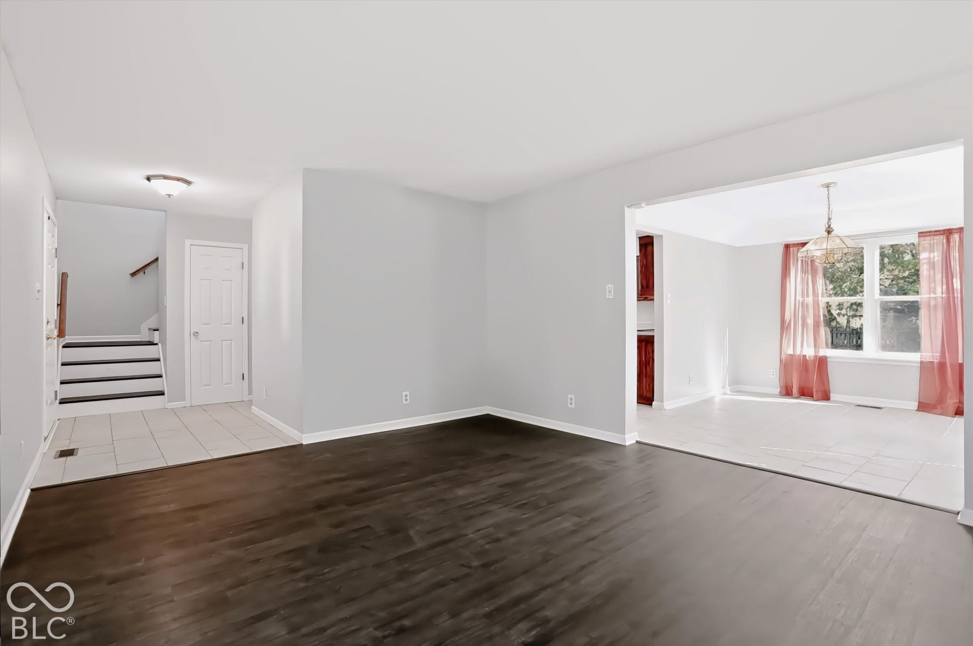 Wood-finish flooring, light gray wall paint, and white trim throughout