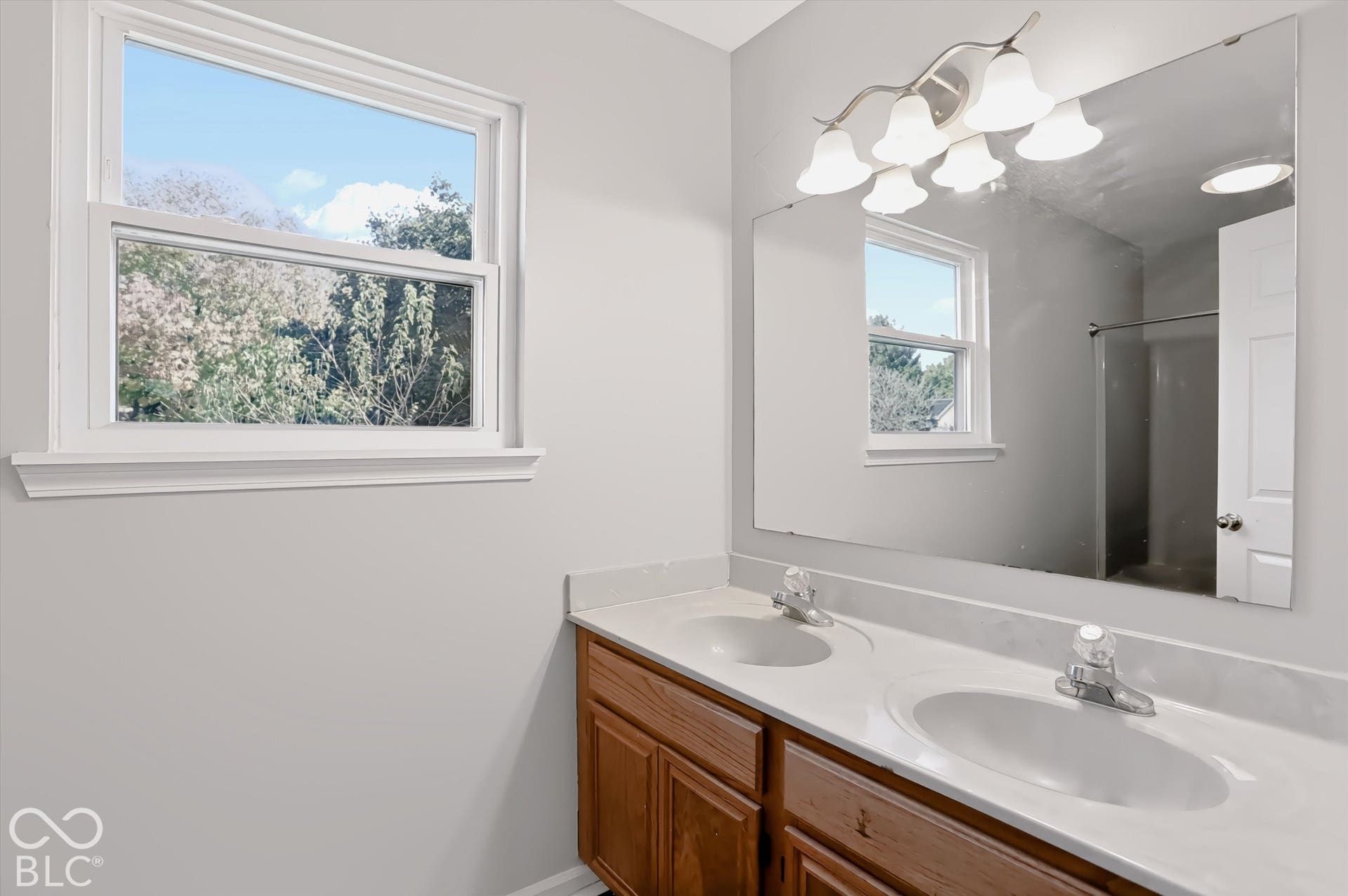 Dual vanity with integrated sinks and white countertops