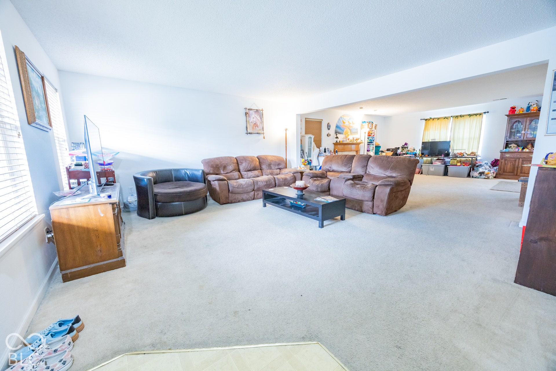 Recessed ceiling, neutral carpet flooring, and white walls