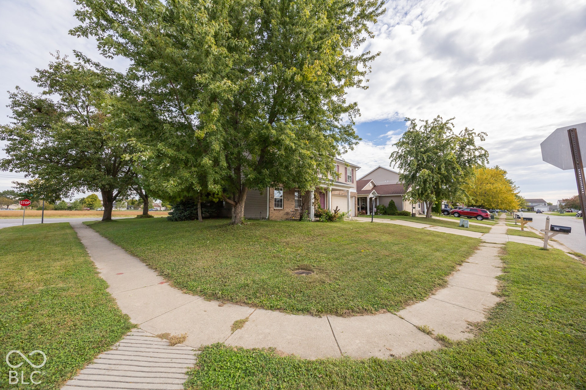 Spacious corner lot featuring mature trees and established landscaping