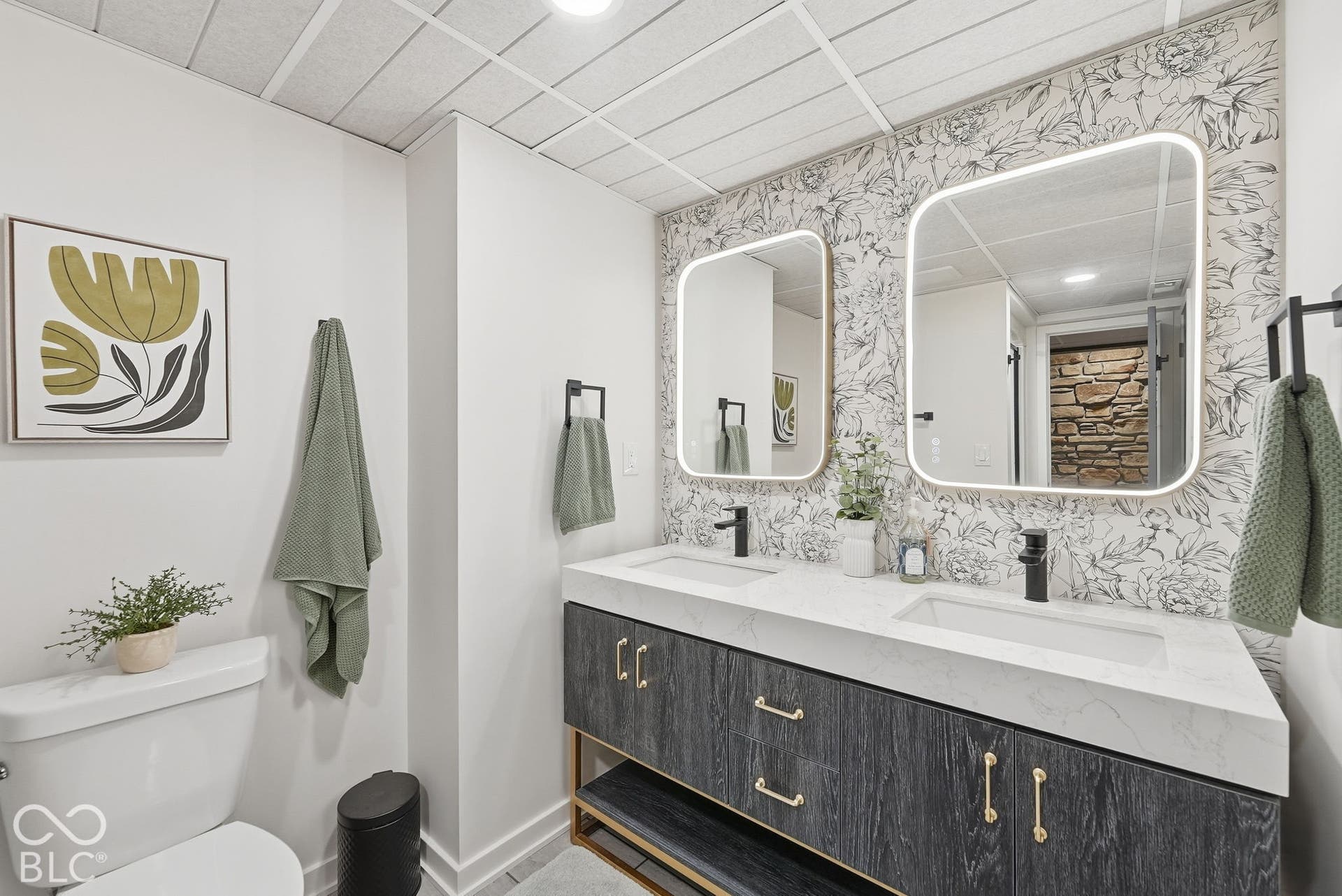 Dual vanities with integrated sinks, quartz countertop, and matte black fixtures