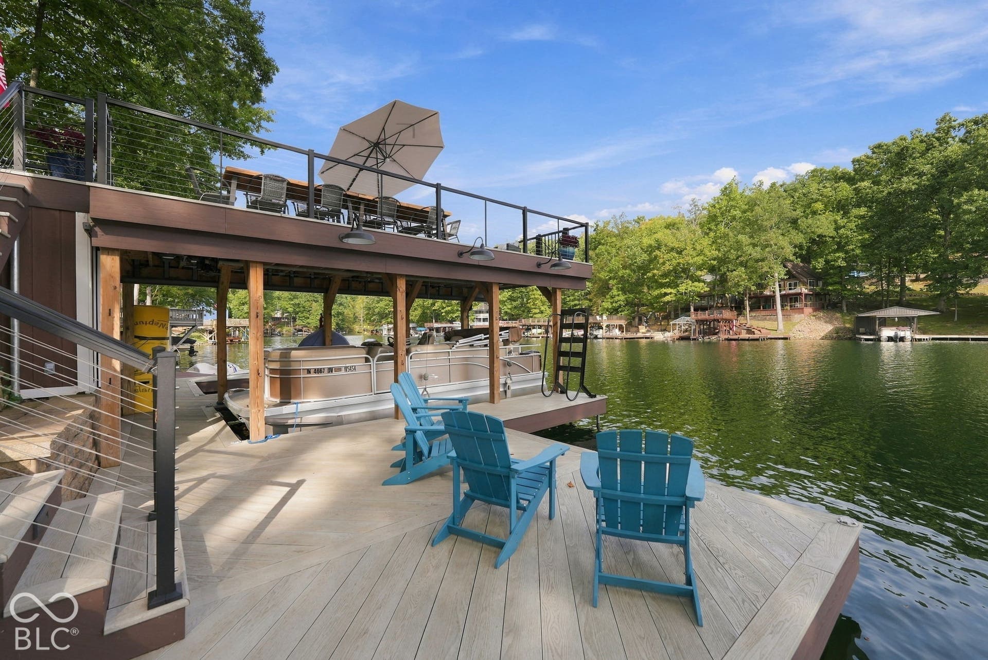 Multi-level dock with composite decking, cable railings, and covered boat slips