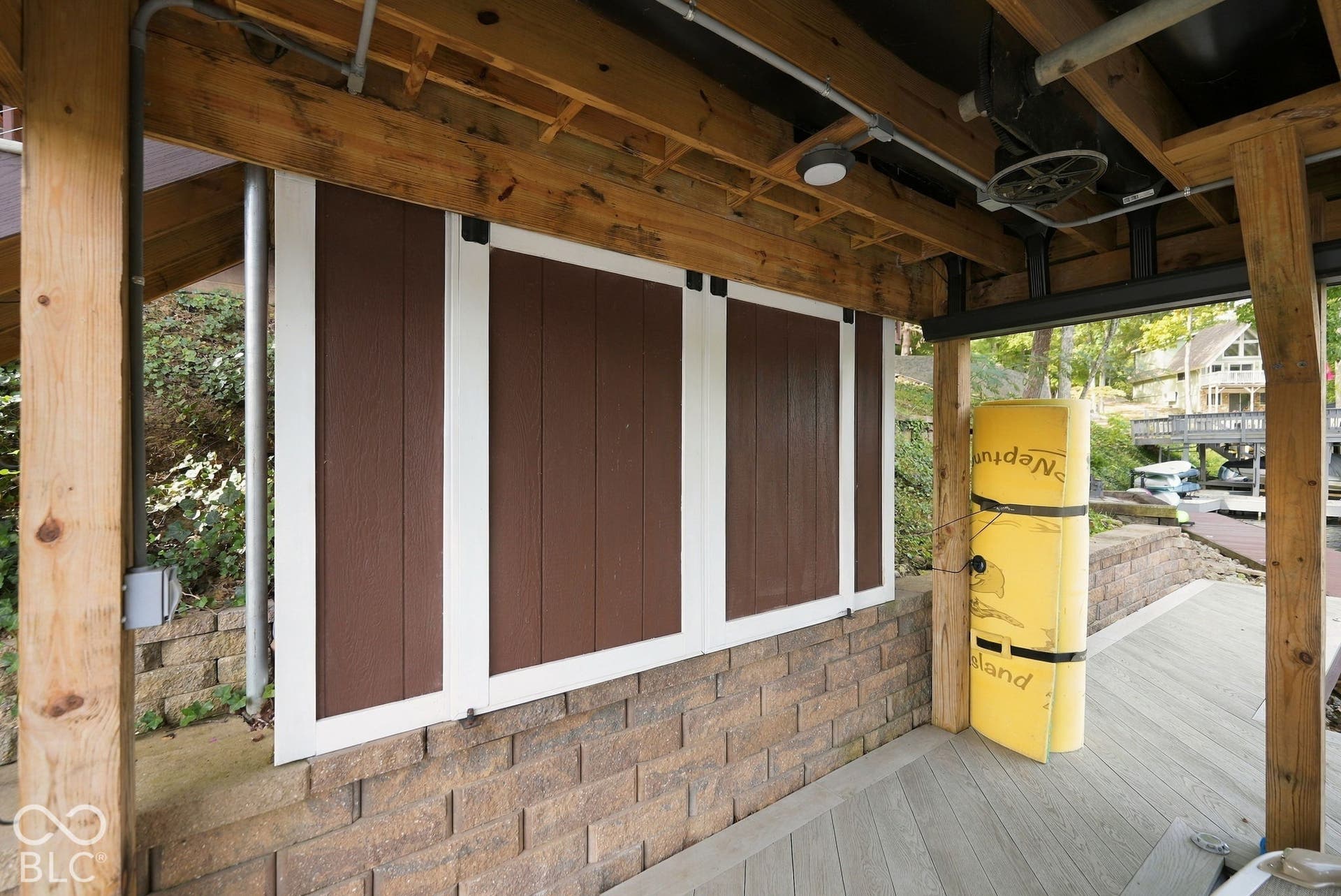 Wood-finish decking with exposed wood beam ceiling