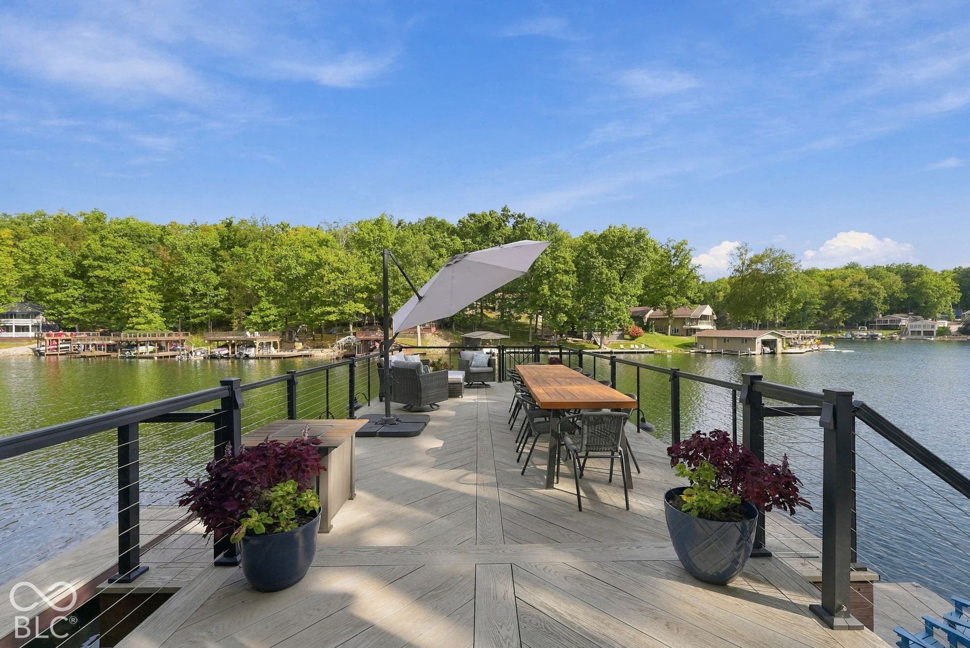Expansive deck with composite decking, cable railing, and waterfront access
