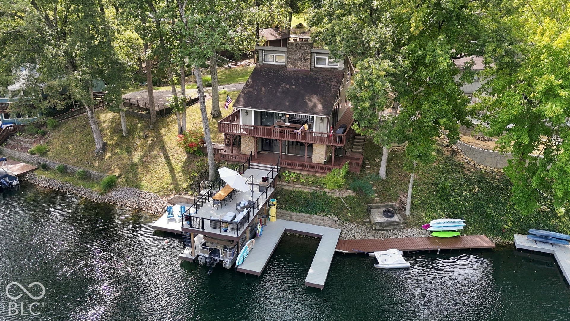 Multi-level waterfront property with stone and siding exterior