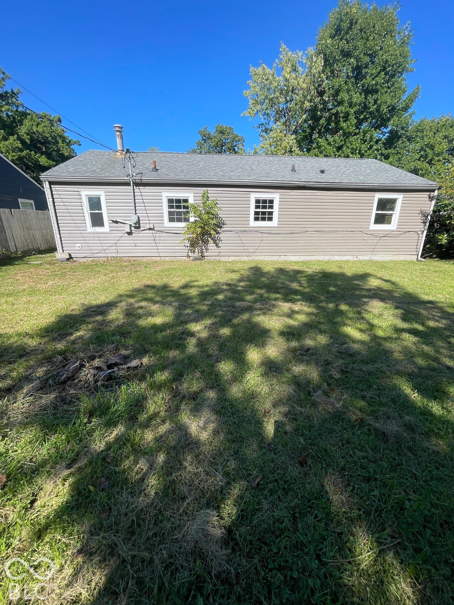 Exterior with horizontal siding, multiple windows, and a gray shingle roof