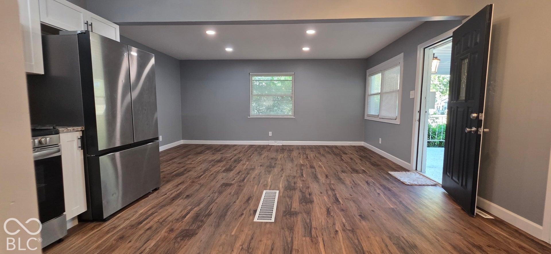 Wood-finish flooring throughout, recessed ceiling lighting, and light gray wall paint