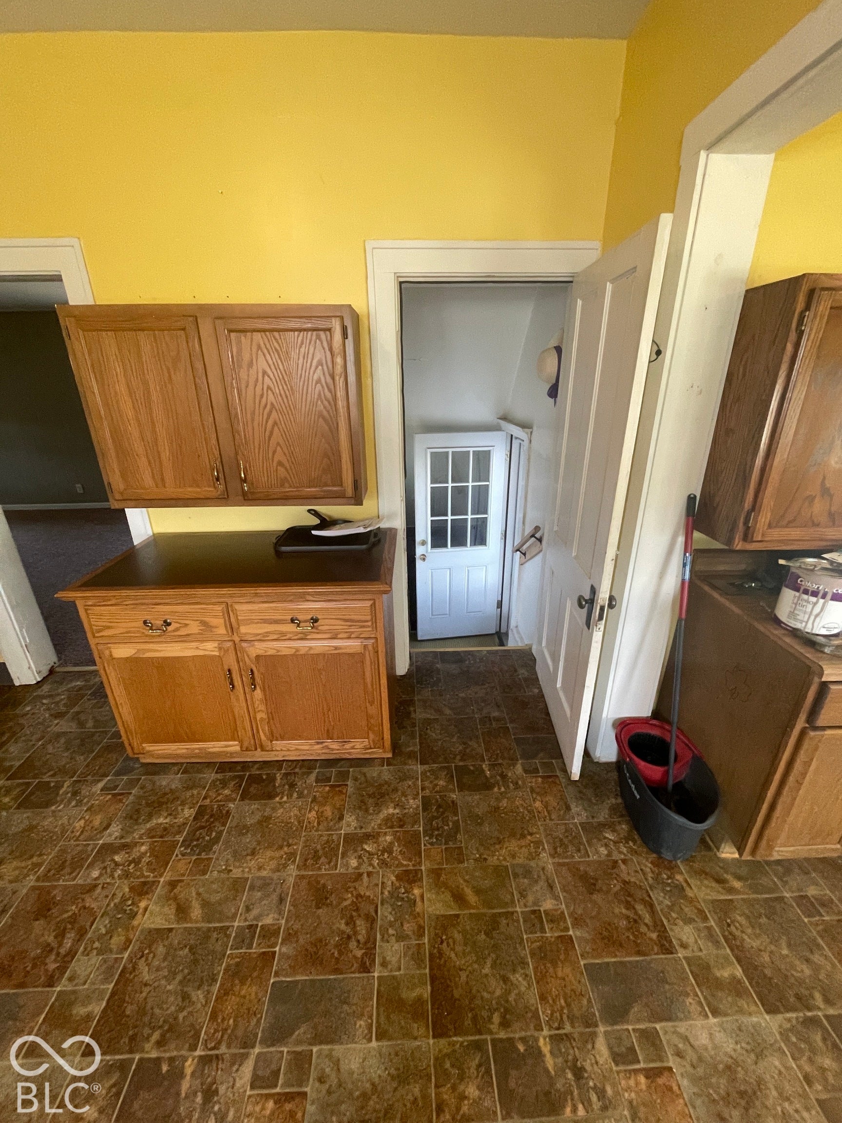 Wood-finish cabinetry and flooring provide functional storage and durability