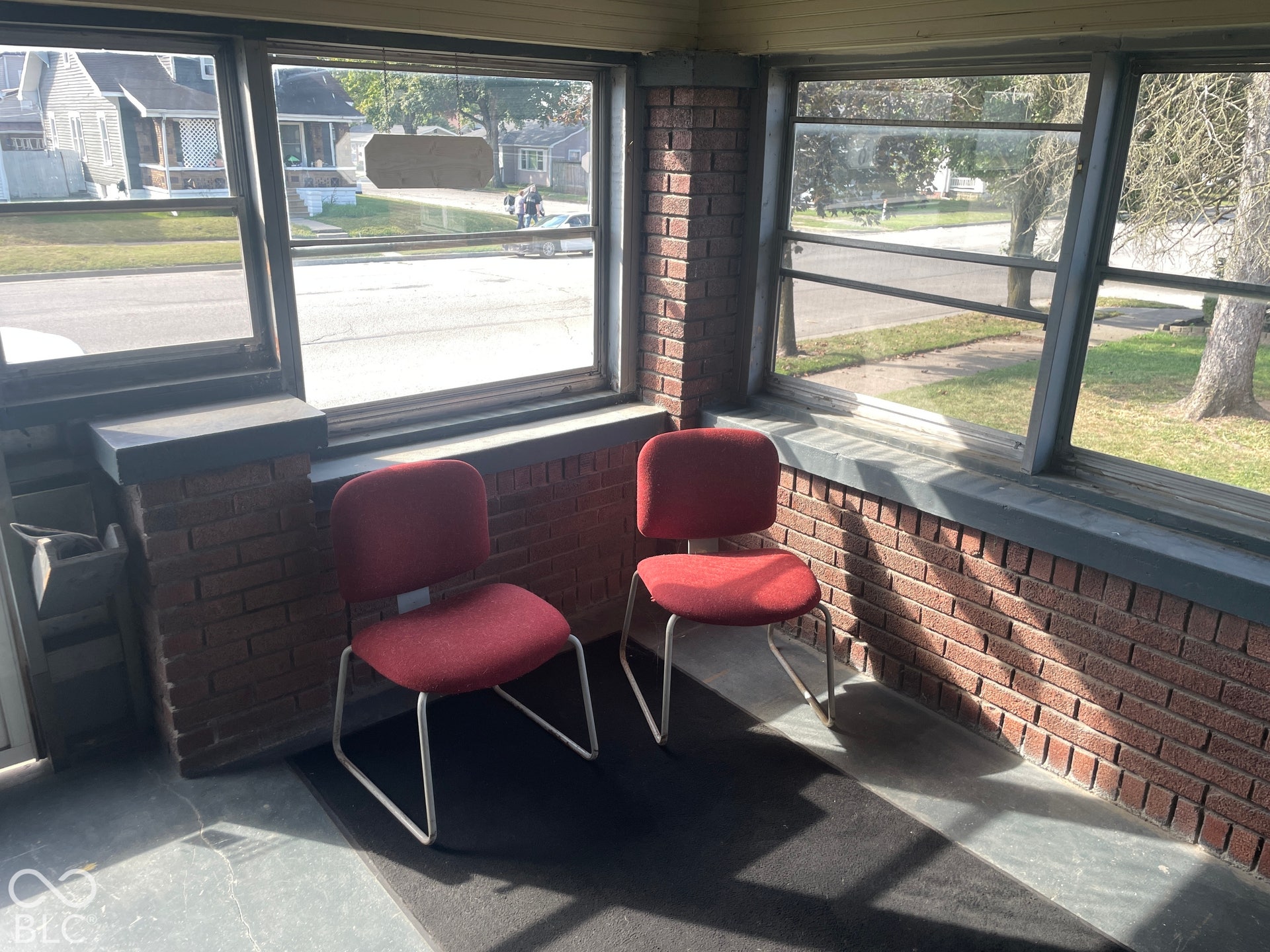 Brick knee wall, multiple windows, window sills, and a wood-paneled ceiling
