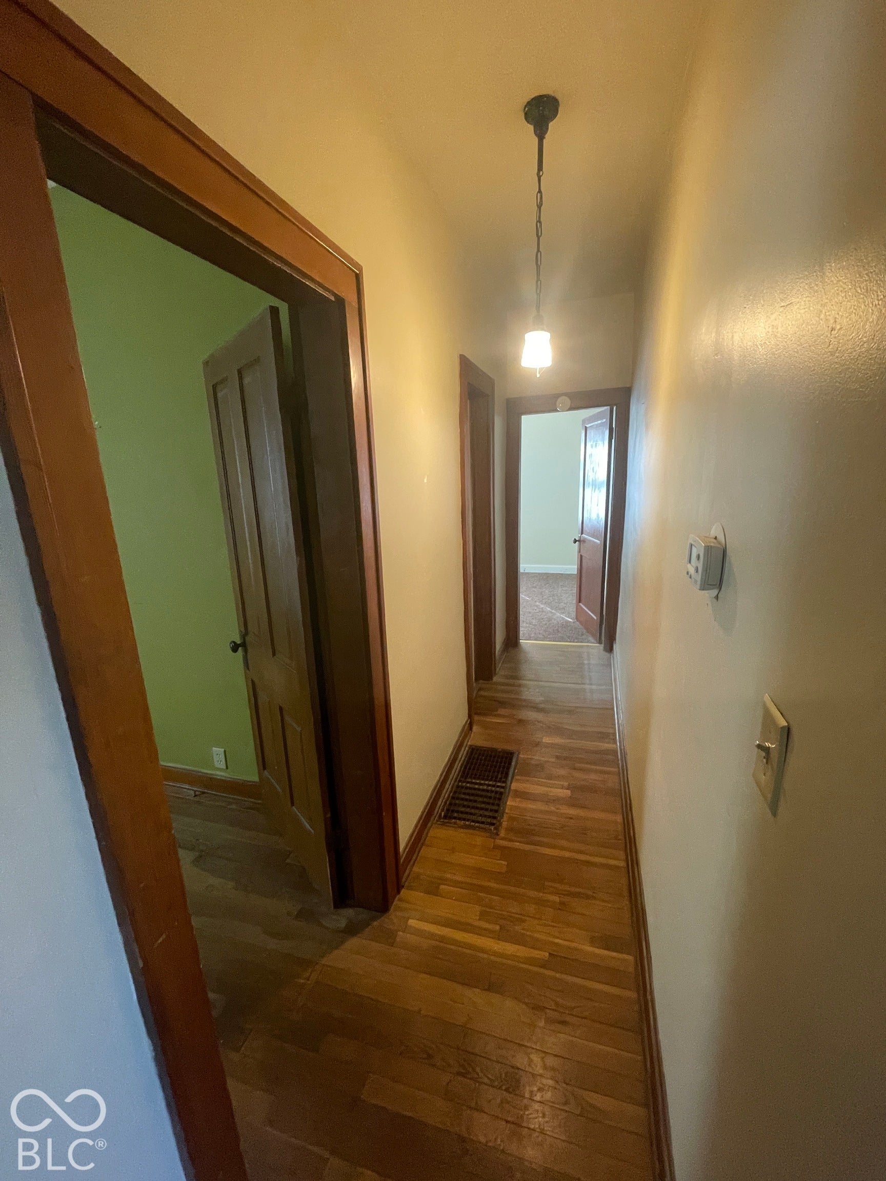 Hardwood flooring throughout, with classic wood trim and solid panel doors