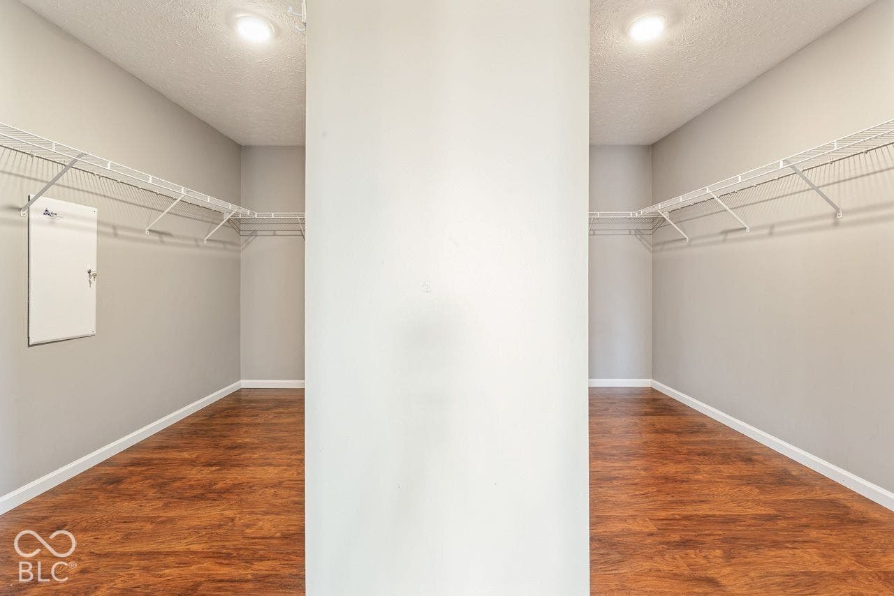 Large walk-in primary closet with his and her sides.