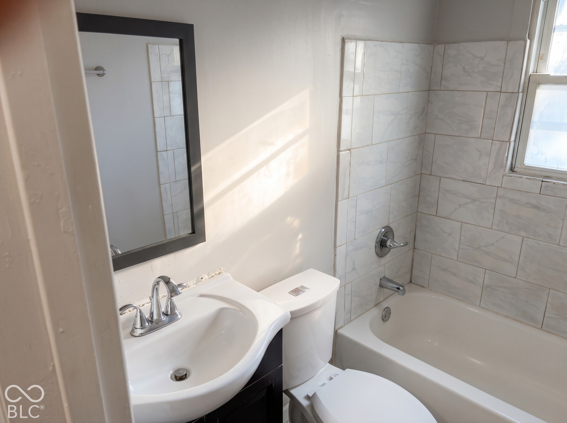 White ceramic tile shower surround