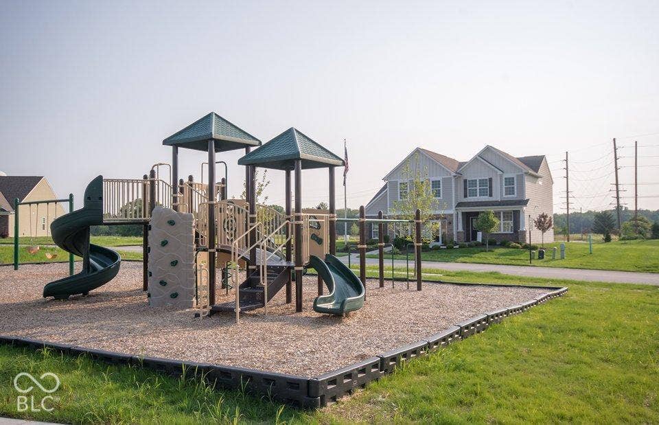Community playground featuring multiple slides and climbing elements