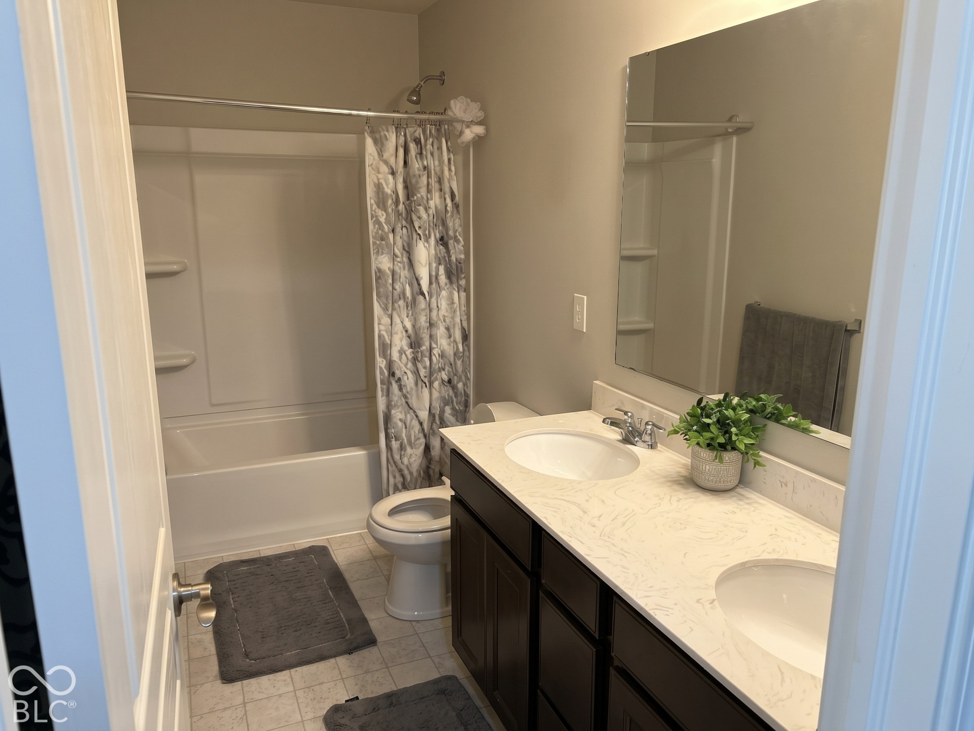 Virtually Altered - Upstairs bathroom with dual vanity with undermount sinks and granite countertops