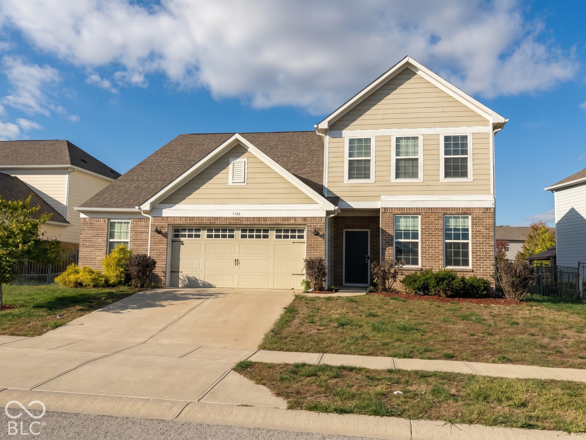 Virtually Altered - Two-story exterior with brick and siding facade, an attached two-car garage, concrete driveway, and front landscaping