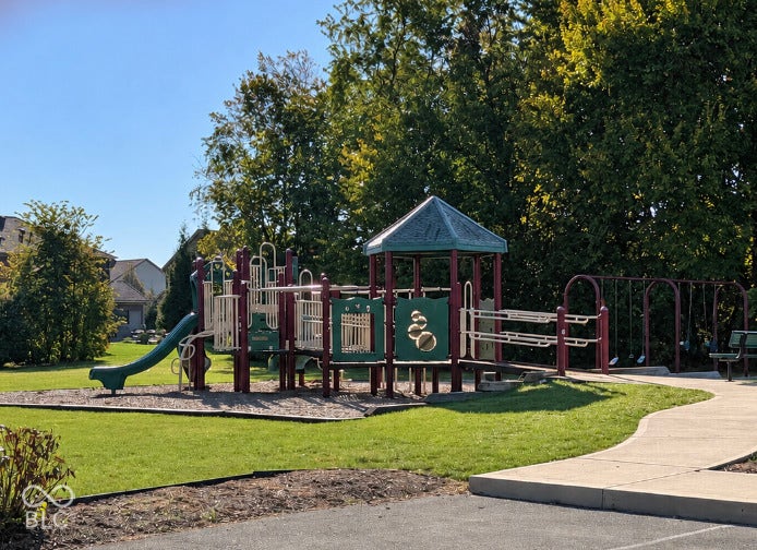 15356 Ackerley Drive, Fishers, IN 46040 Community playground featuring a slide, swings, and climbing structures