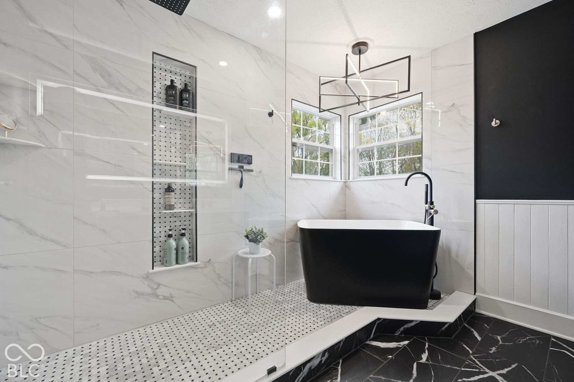 The Primary Bathroom Features A Japanese Soaker Tub & A Large Walk-In Shower With A Moen Digital Shower System, Rainfall Shower & Carrara Marble Floors & Shelf