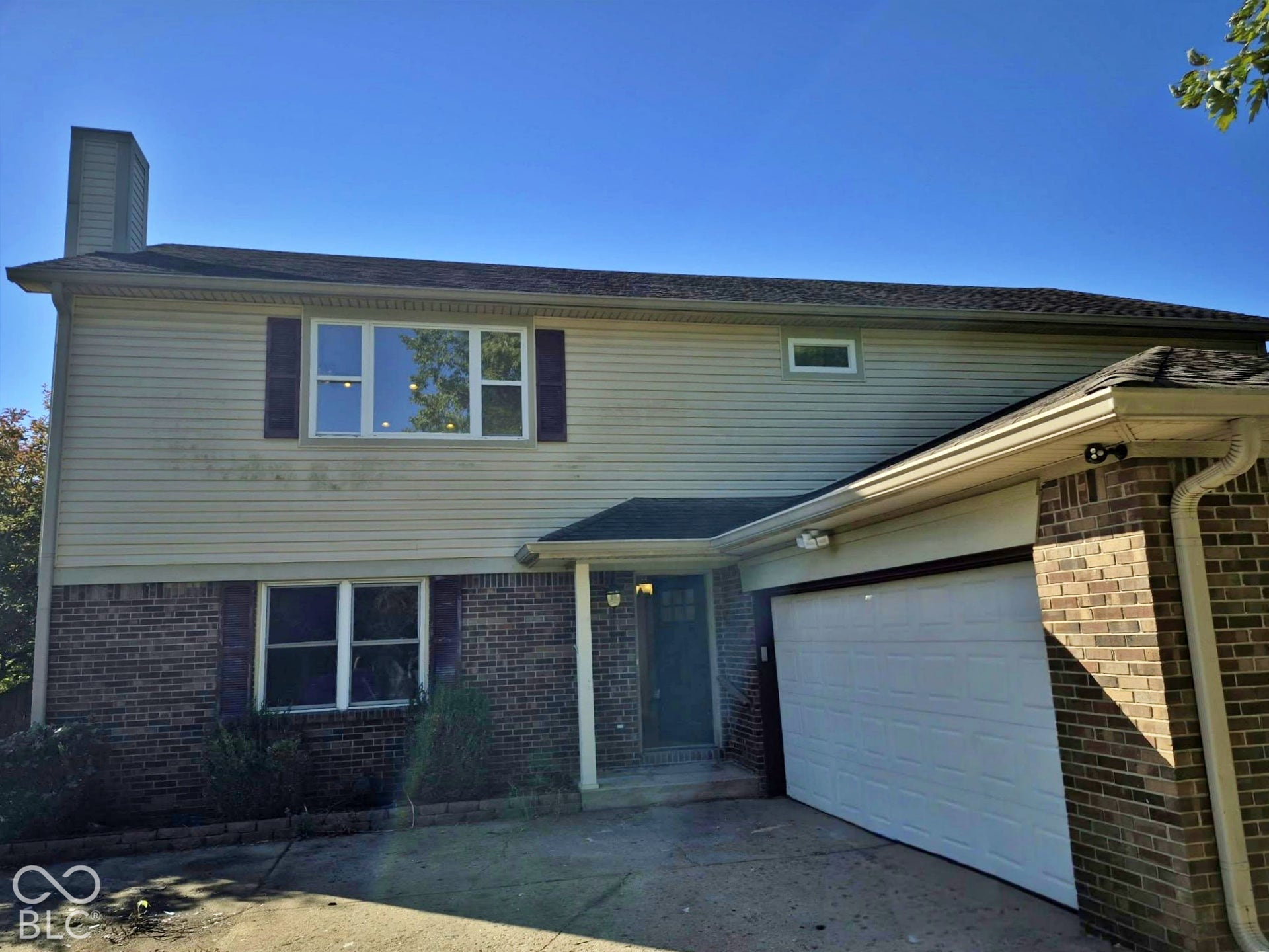 Brick and siding exterior with a shingle roof