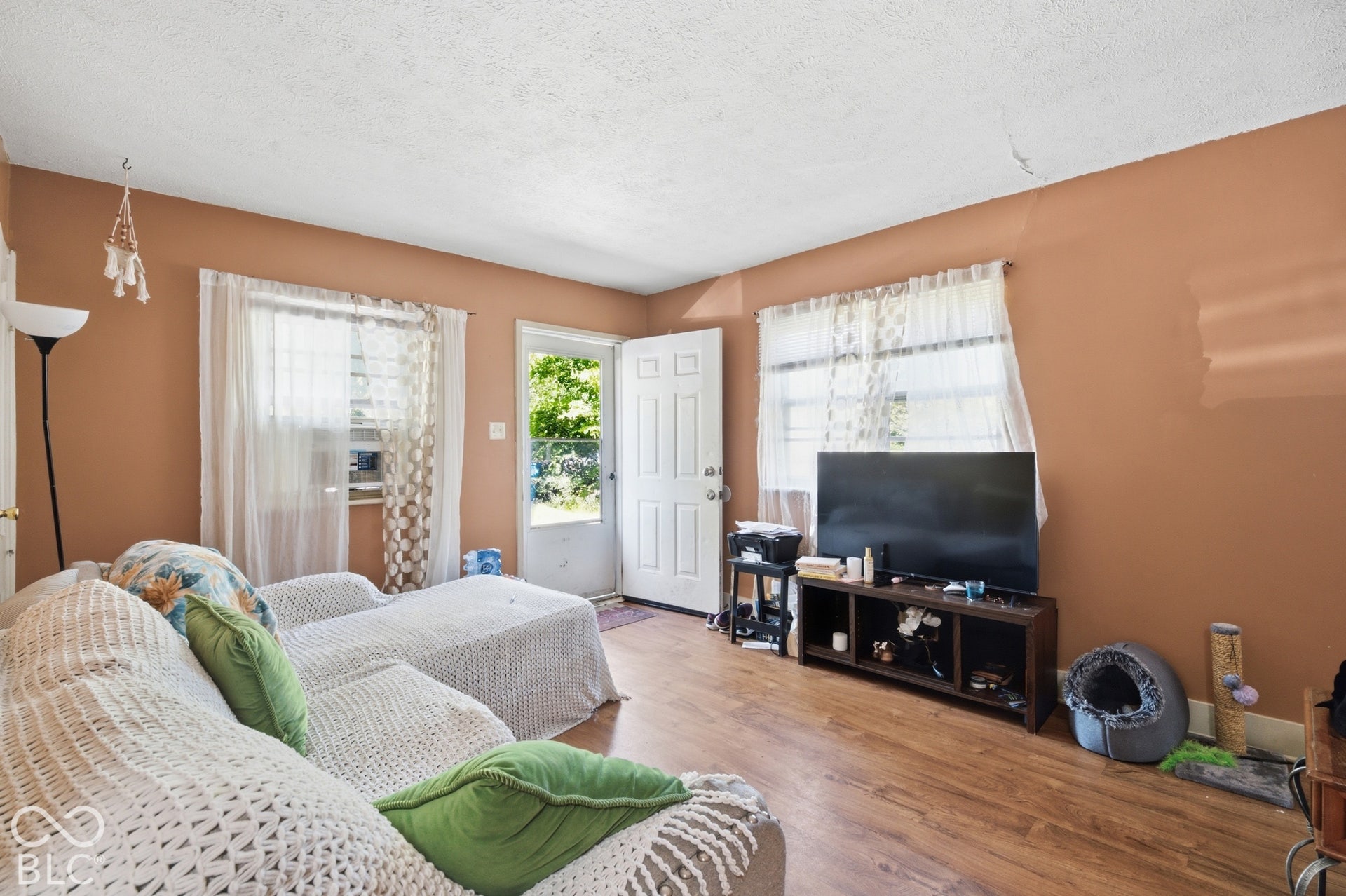 1273 Farley, Indianapolis, IN 46214 Wood-finish flooring throughout, light-toned wall paint, and multiple windows providing natural illumination